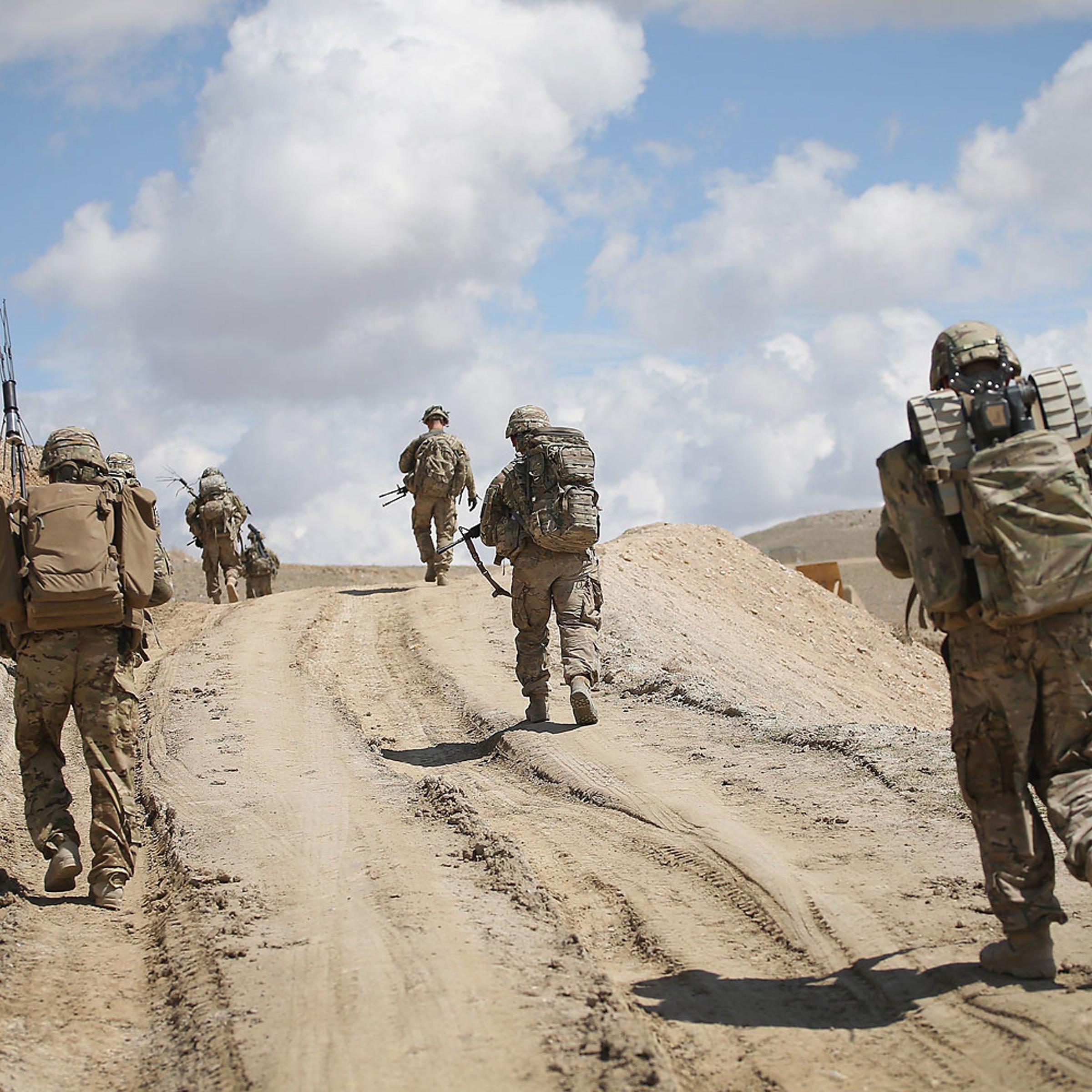 Soldiers with the U.S. Army's 2nd Battalion 87th Infantry Regiment, 3rd Brigade Combat Team, 10th Mountain Division patrol on the edge of a village outside of Forward Operating Base Shank on March 29, 2014 near Pul-e Alam, Afghanistan.
