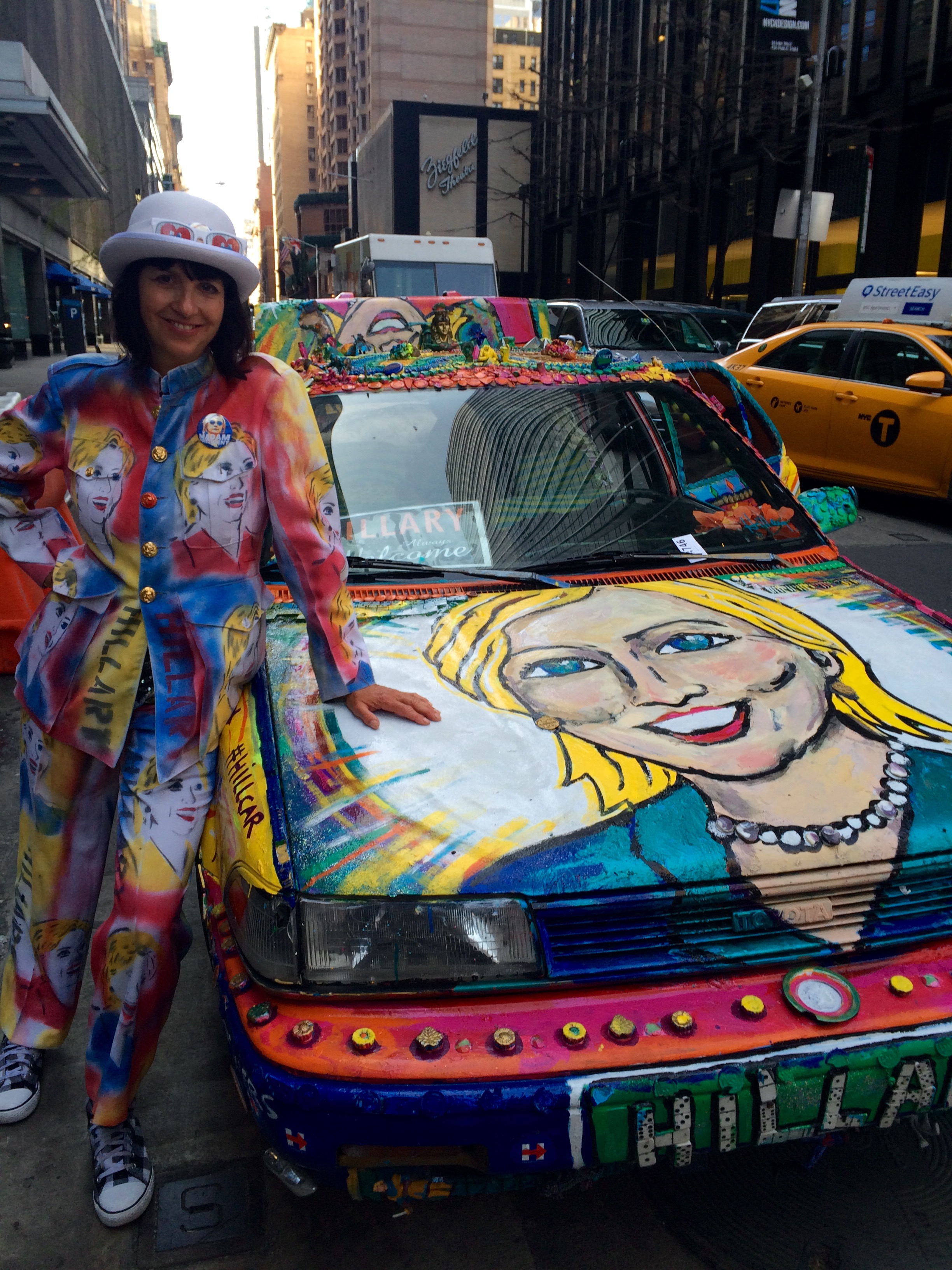 Gretchen Baer in her Hillary Clinton pantsuit, next to her Hillary Clinton car