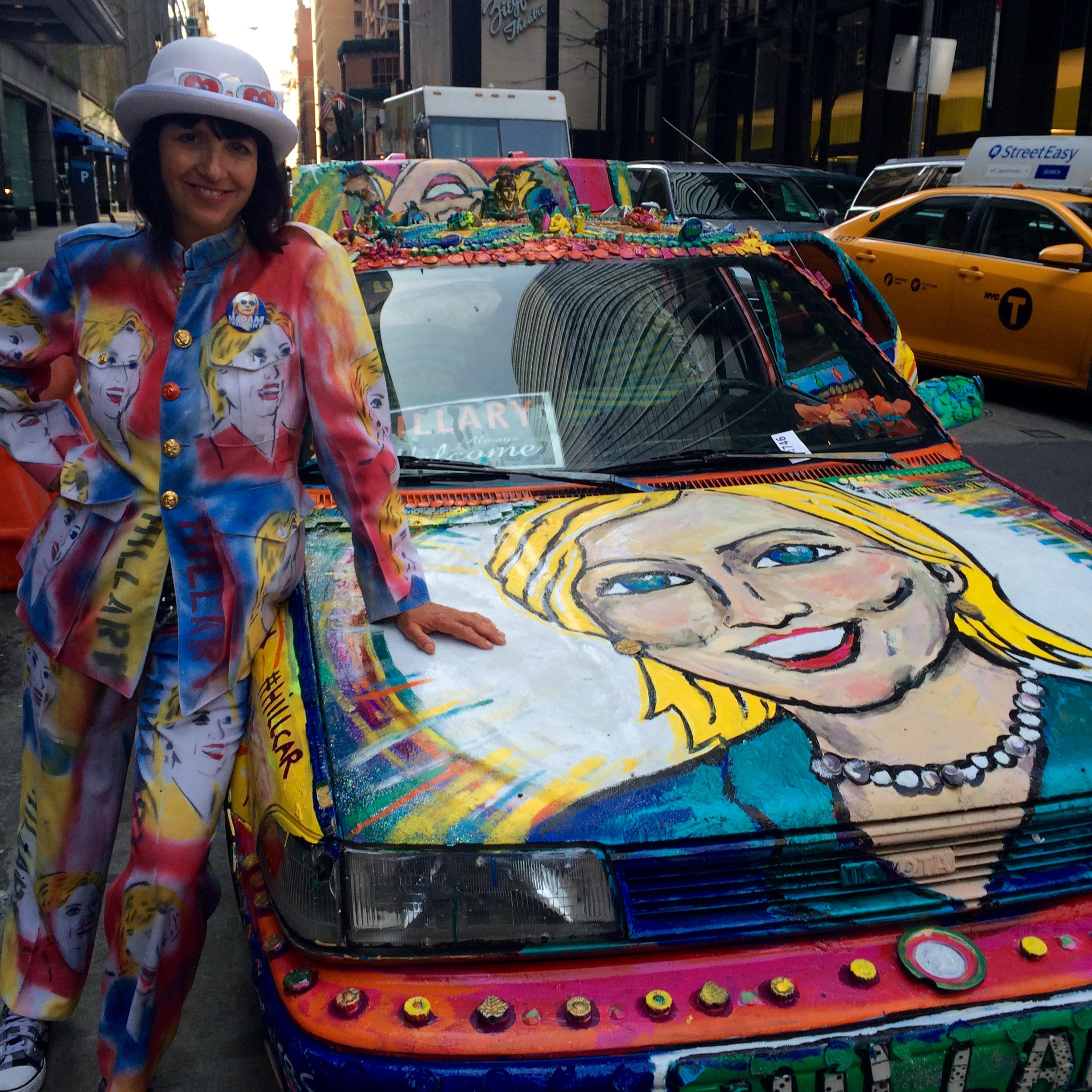 Gretchen Baer in her Hillary Clinton pantsuit, next to her Hillary Clinton car