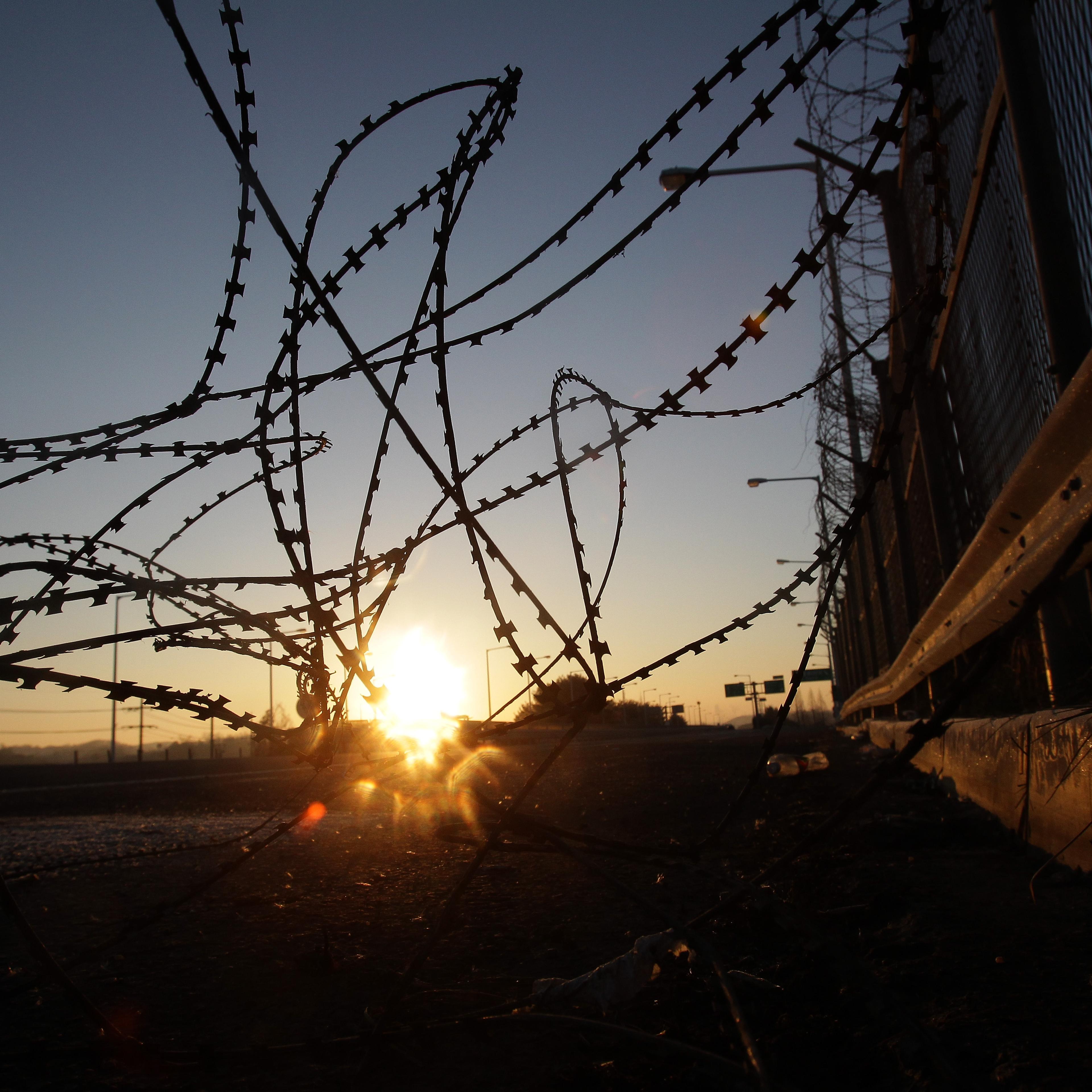A sunrise is seen through a barbed-wire fence at the Imjingak, near the Demilitarized zone separating South and North Korea in Paju, South Korea, on Jan. 8, 2016.