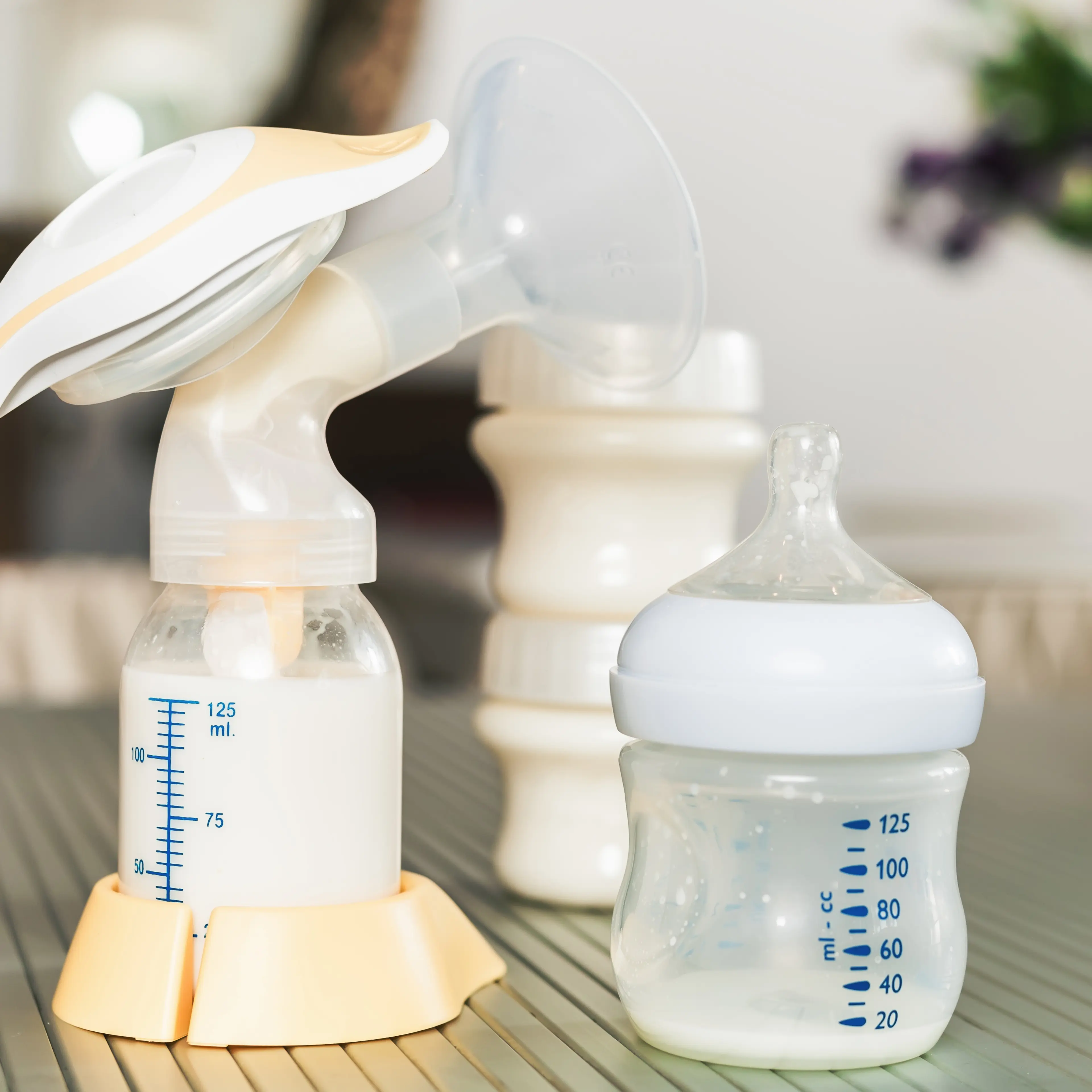 Baby bottle with milk and manual breast pump