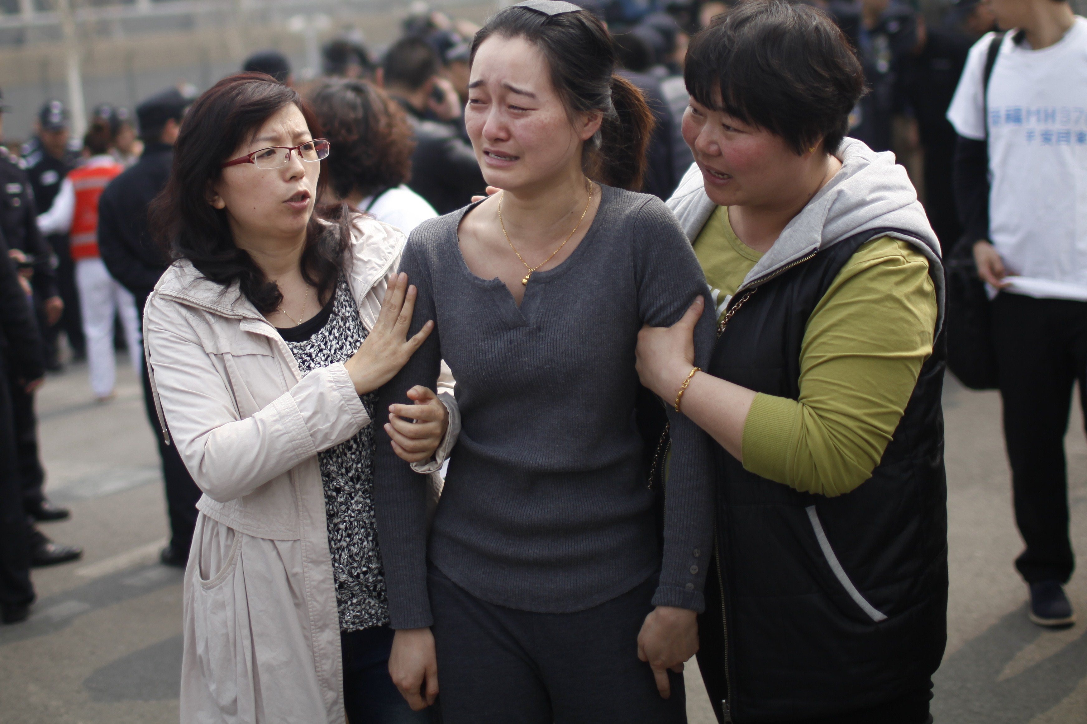 A relative of passengers on the missing Malaysia Airlines flight MH370 cries as she participates in a protest outside the Malaysian embassy in Beijing on March 25, 2014.