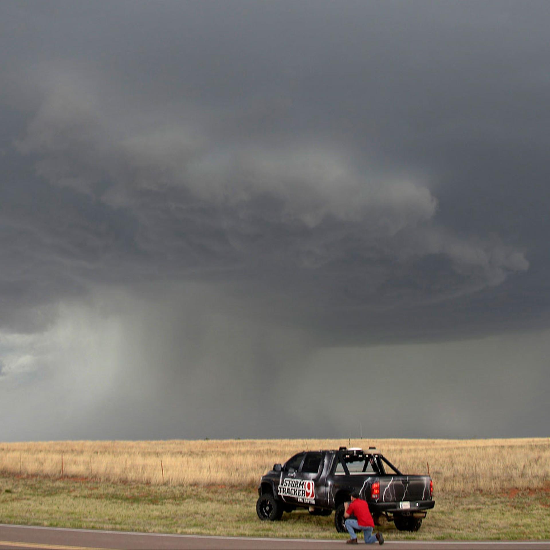A storm chaser photographer looks at thunderstorms supercells pass through areas in Vinson, Oklahoma