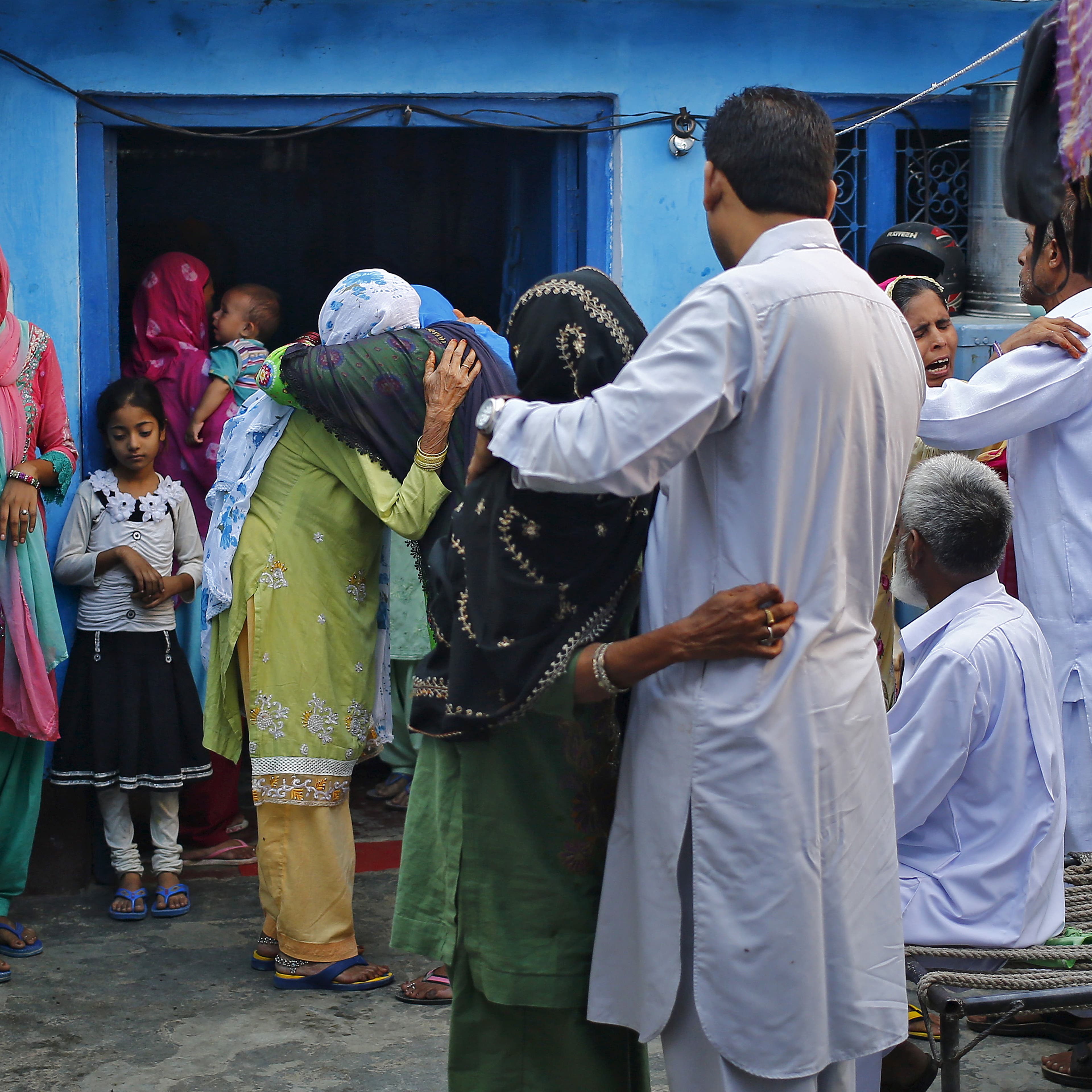 Relatives and family members of Saifi, who was killed by a mob, mourn his death at Bisara village in Uttar Pradesh