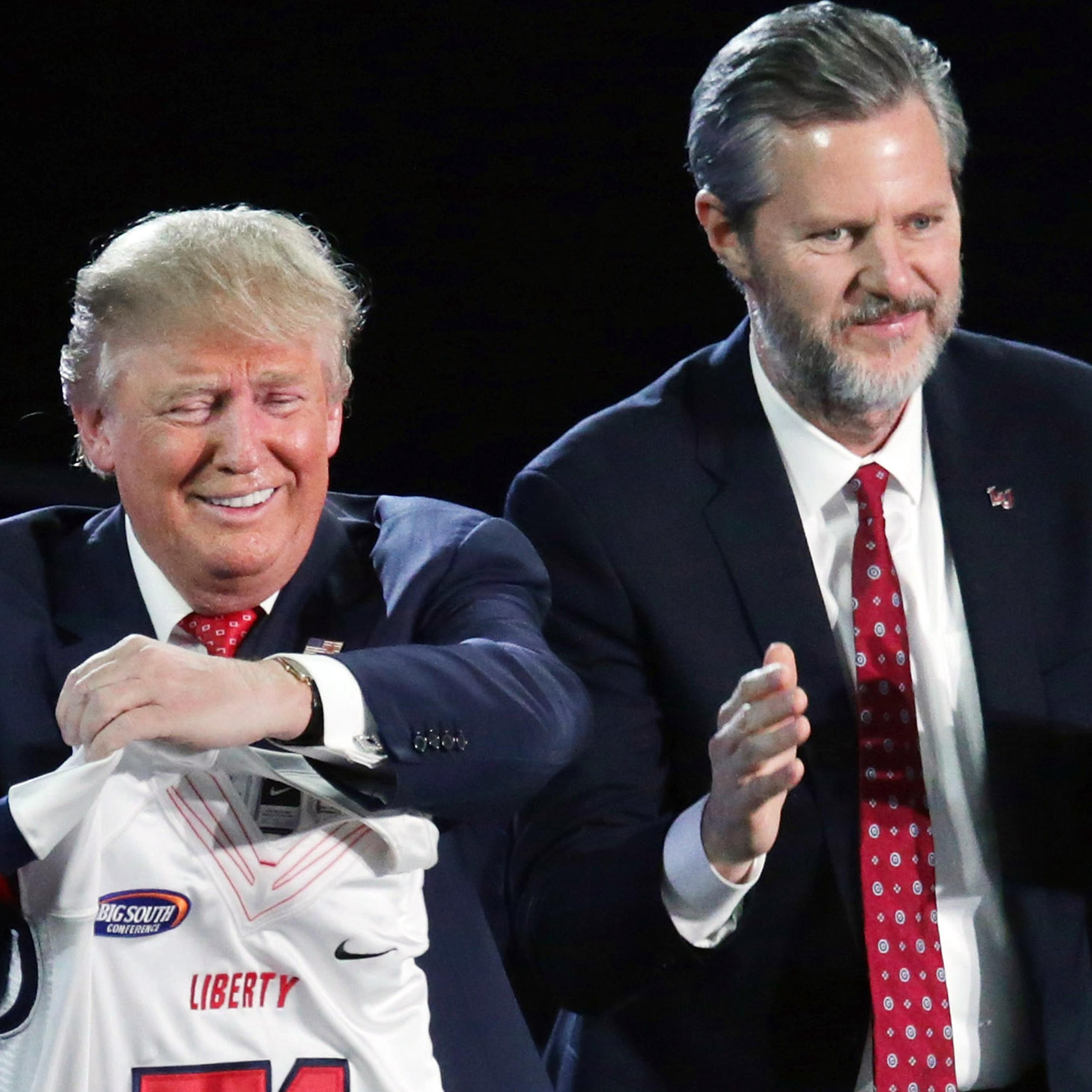Jerry Falwell, Jr. presents Republican presidential candidate Donald Trump with a sports jersey after he delivered the convocation on Jan. 18, 2016 in Lynchburg, Va.