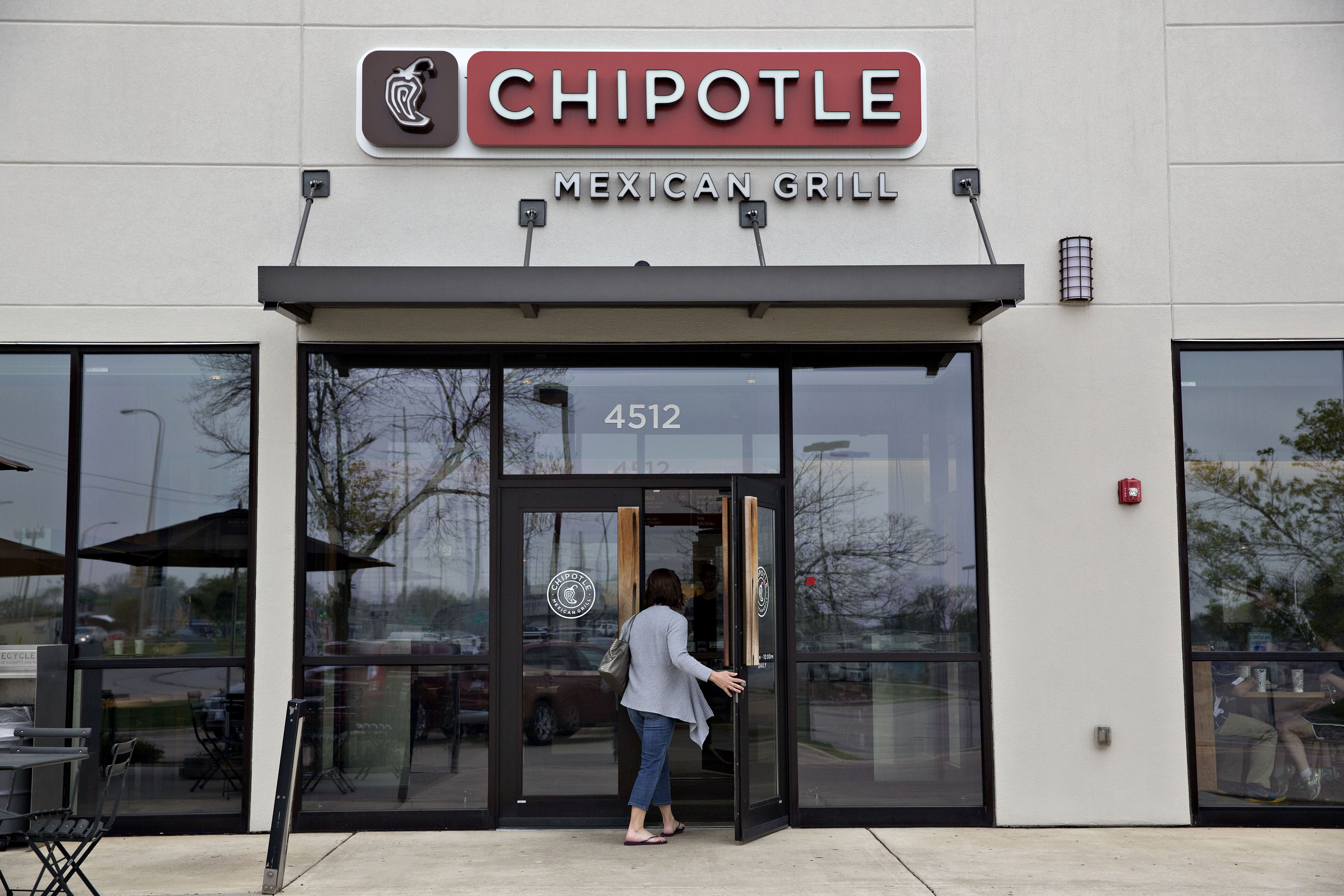 A customer enters a Chipotle Mexican Grill Inc. restaurant in Peoria, Illinois, on April 22, 2016.