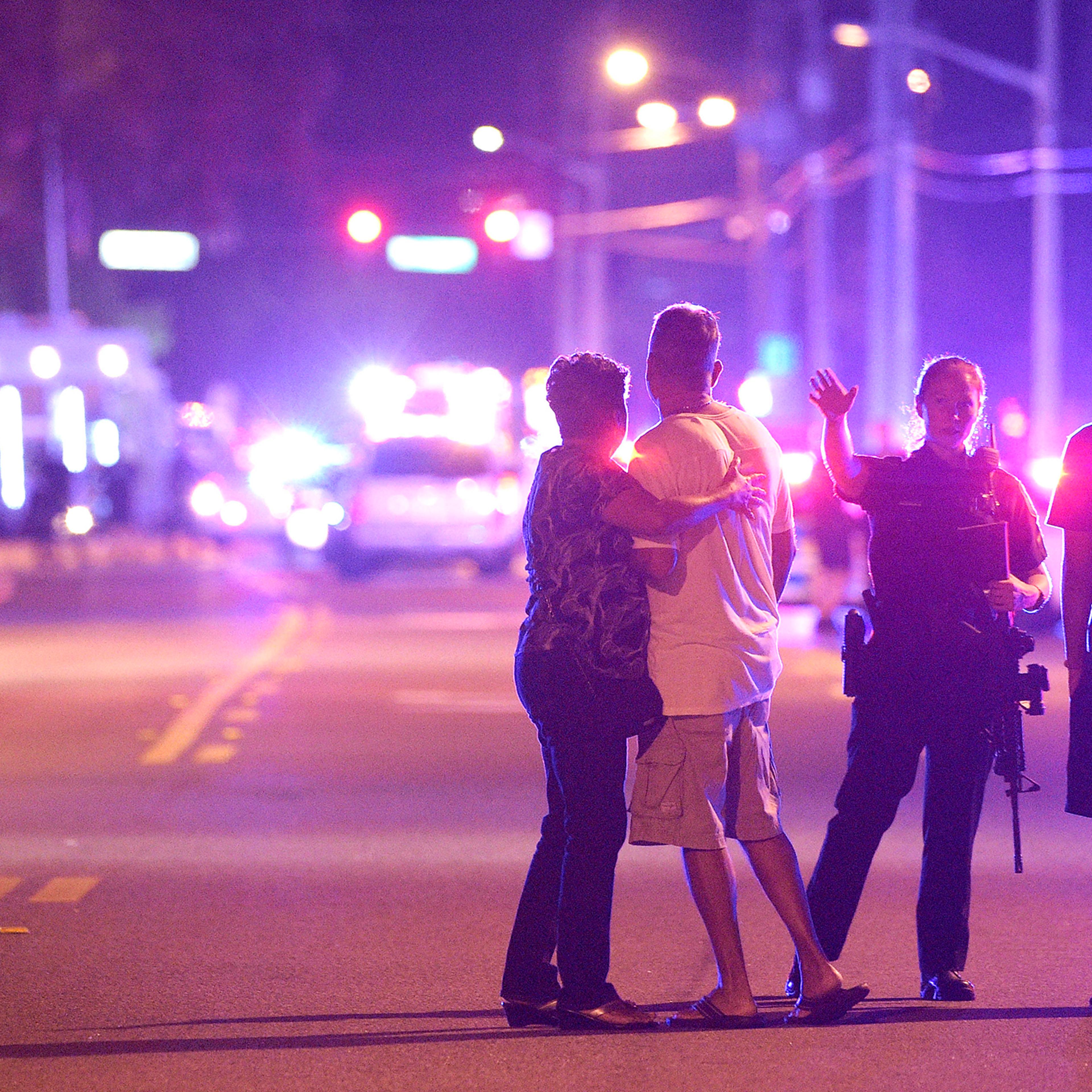 Orlando Police officers direct family members away from a fatal shooting at Pulse Orlando nightclub in Orlando, Florida, June 12, 2016.