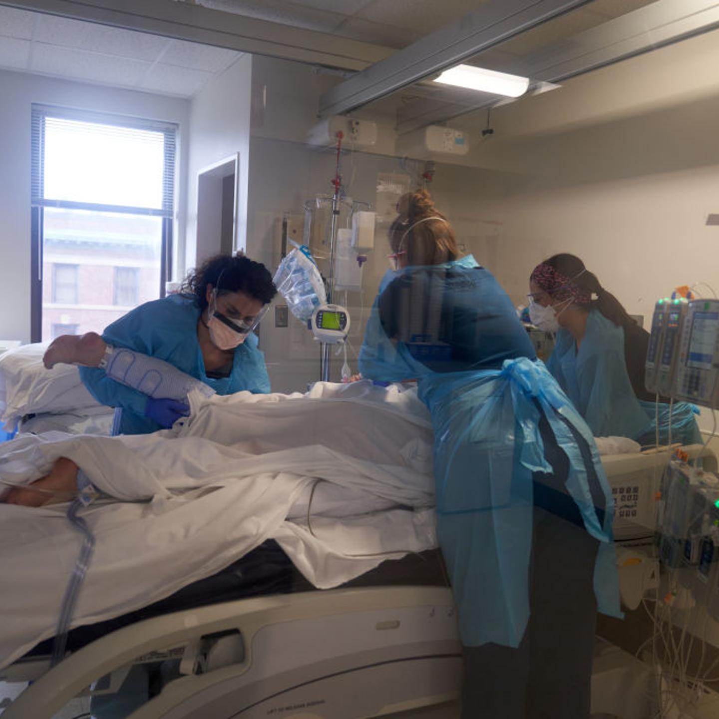 Healthcare workers treat a patient on the Covid-19 ICU floor of the University of Massachusetts Memorial Hospital on Dec. 27, 2021.