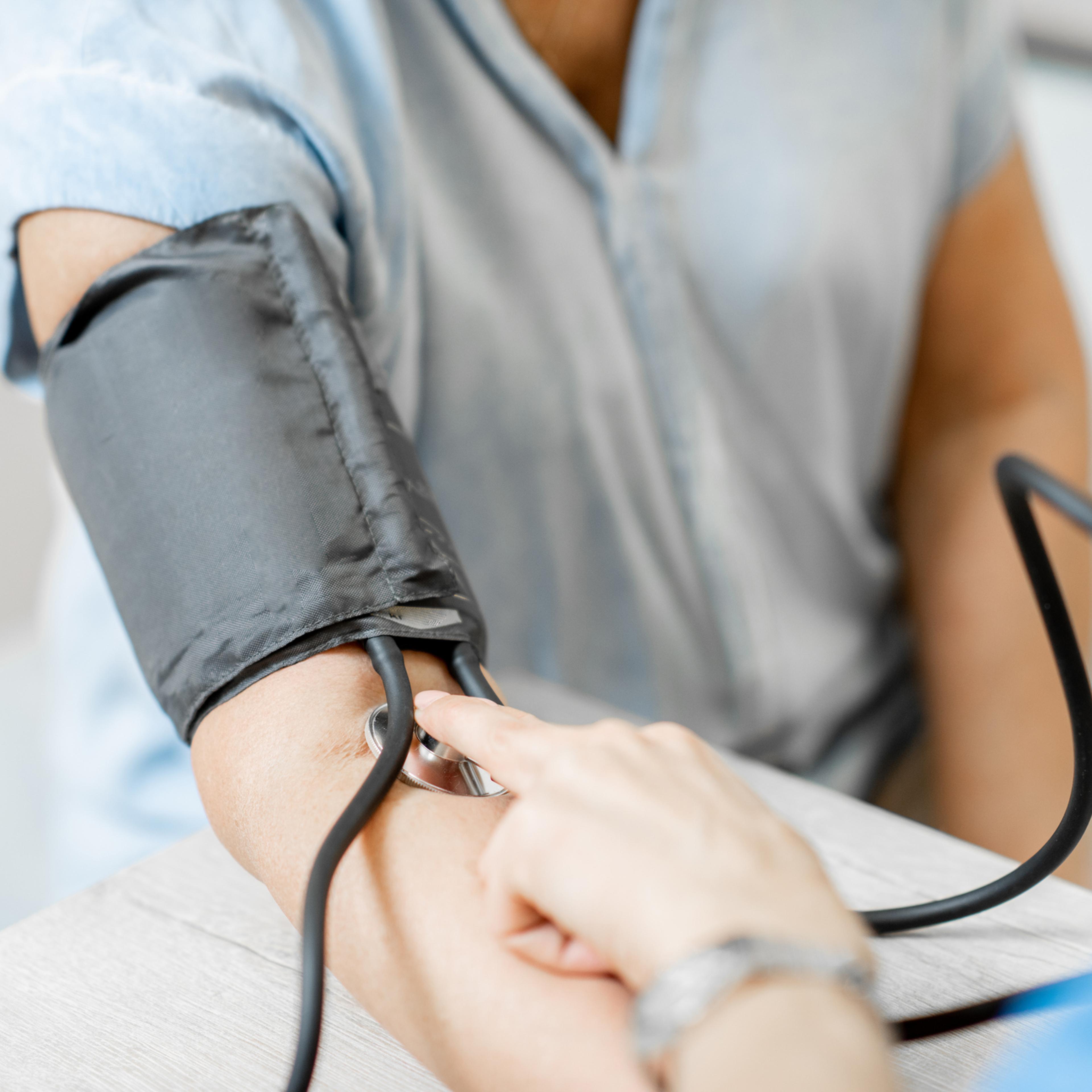 Nurse measuring blood pressure of a senior patient