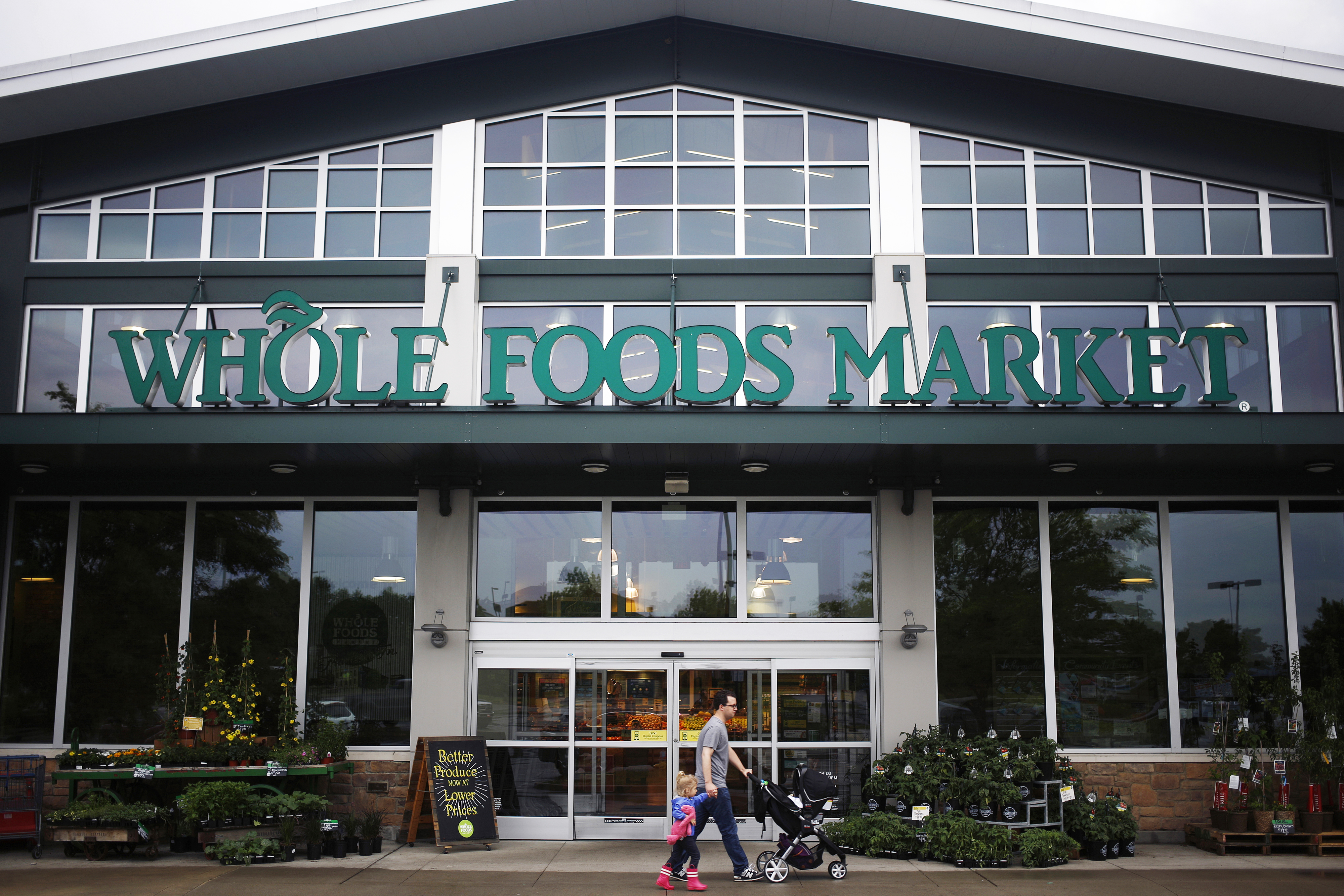 A shopper walks in front of a Whole Foods store in Franklin, Tenn. on April 30, 2016.