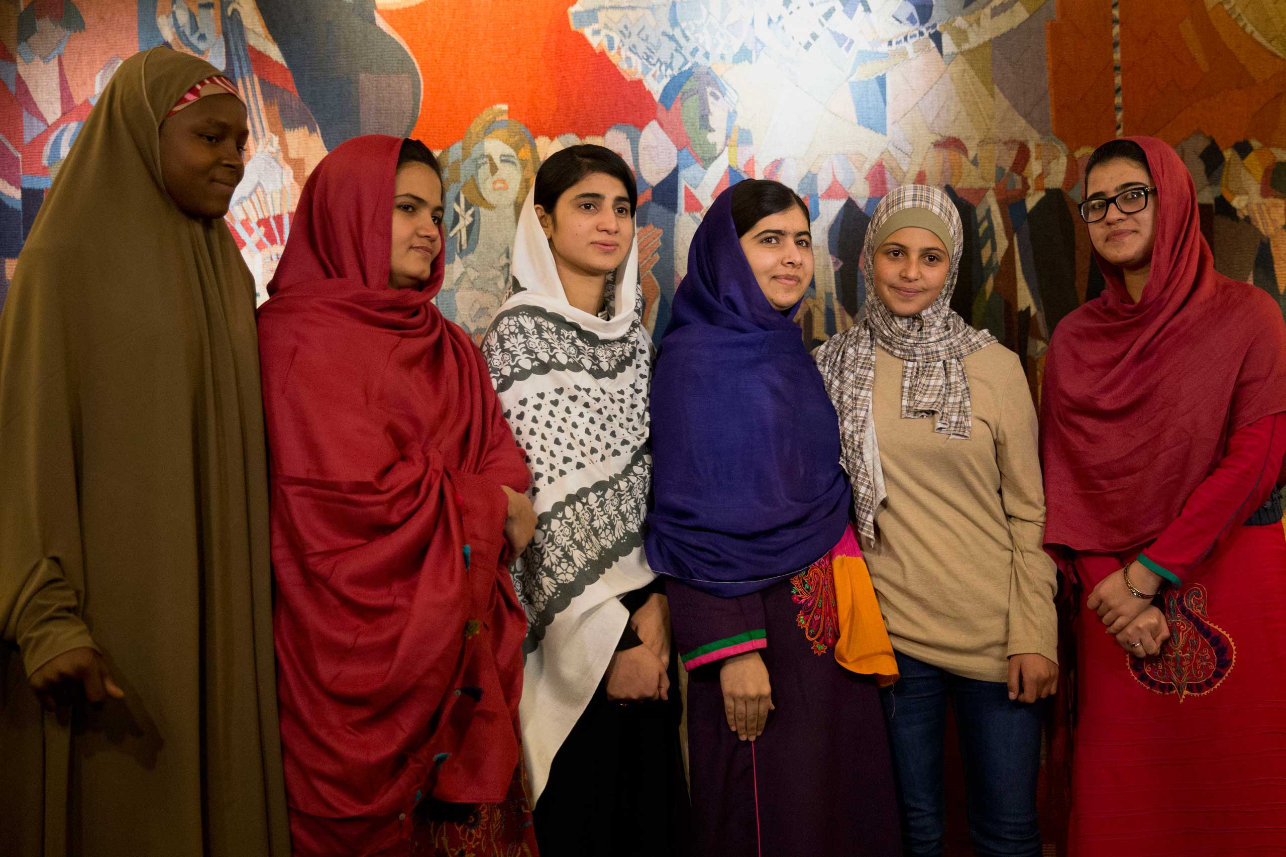 Joint Nobel Peace prize winner Malala Yousafzai, stands with five young women she invited to attend the Nobel Peace Prize ceremony, from left, Nigeria's Amina Yusuf, Pakistan's Kainat Soomro, school friend Shazia Ramzan, Syria's Mezon Almellehan and scho