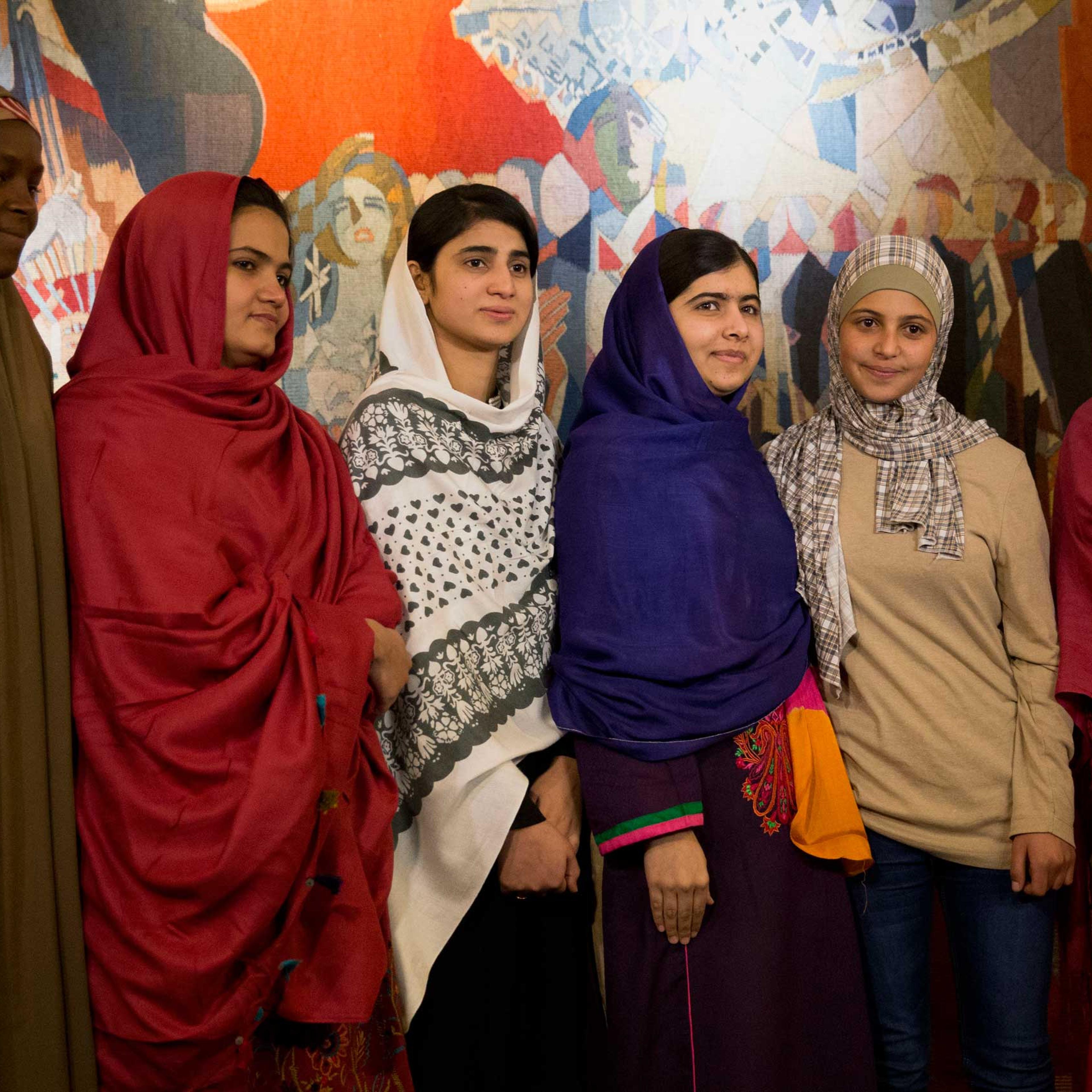 Joint Nobel Peace prize winner Malala Yousafzai, stands with five young women she invited to attend the Nobel Peace Prize ceremony, from left, Nigeria's Amina Yusuf, Pakistan's Kainat Soomro, school friend Shazia Ramzan, Syria's Mezon Almellehan and scho