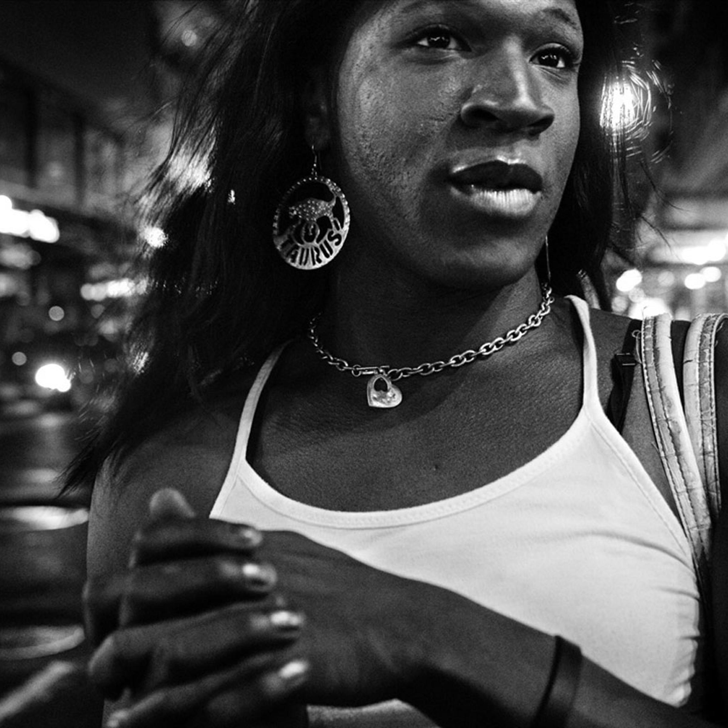 K. pauses on 34th Street while on her way to the Village. August 2006.<br /><br />
Transgender people comprise the highest proportion of homeless LGBT youth. In particular, they are often denied access to shelter services, particularly in shelters that segregate clients based on birth sex. Discrimination and lack of identification that reflects their chosen name and gender makes it hard for many young transwomen to find a legal job, leaving sex work as one of the few options available to them.