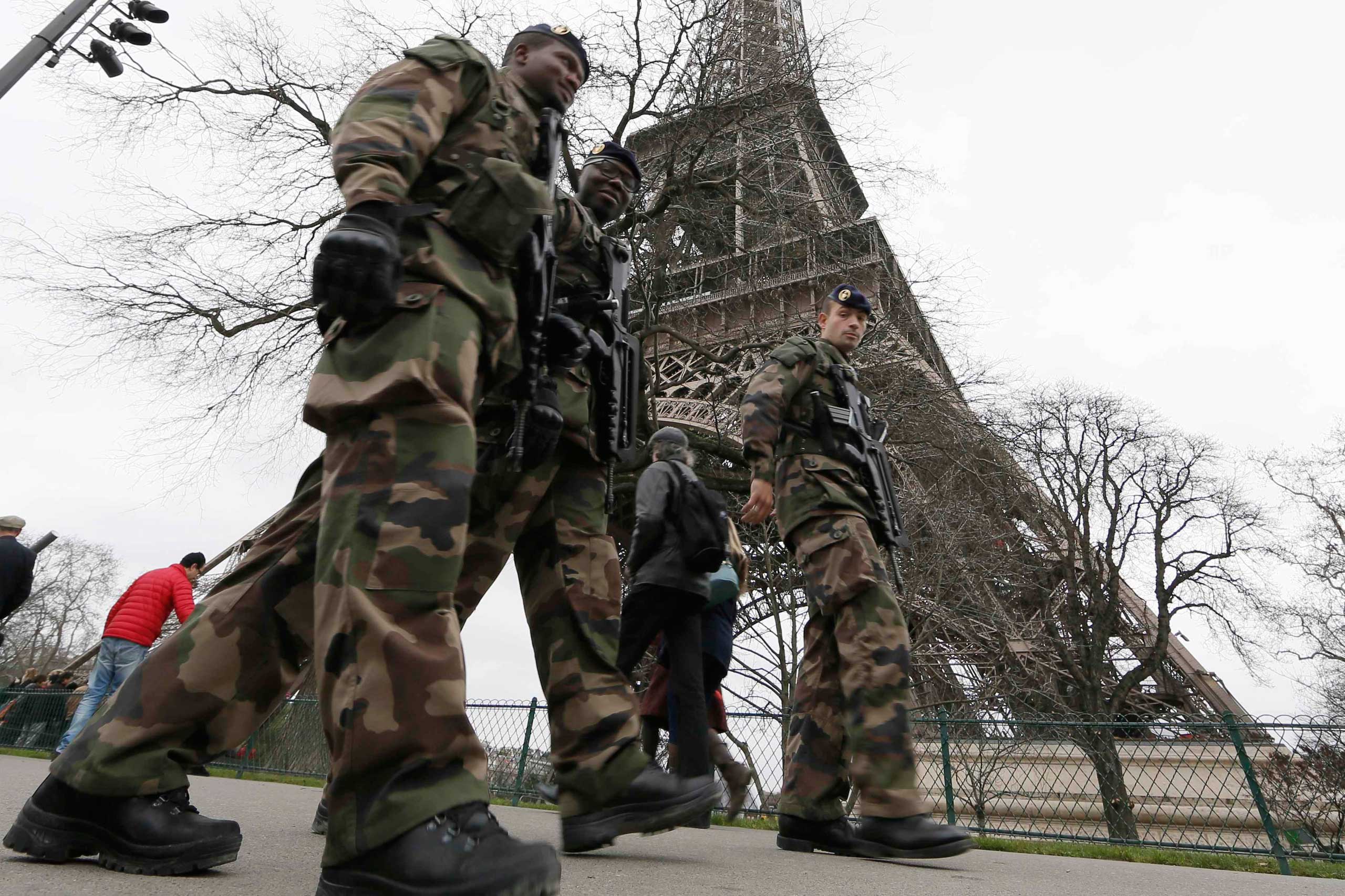 French soldiers patrol near the Eiffel Tower in Paris as part of the "Vigipirate" security plan