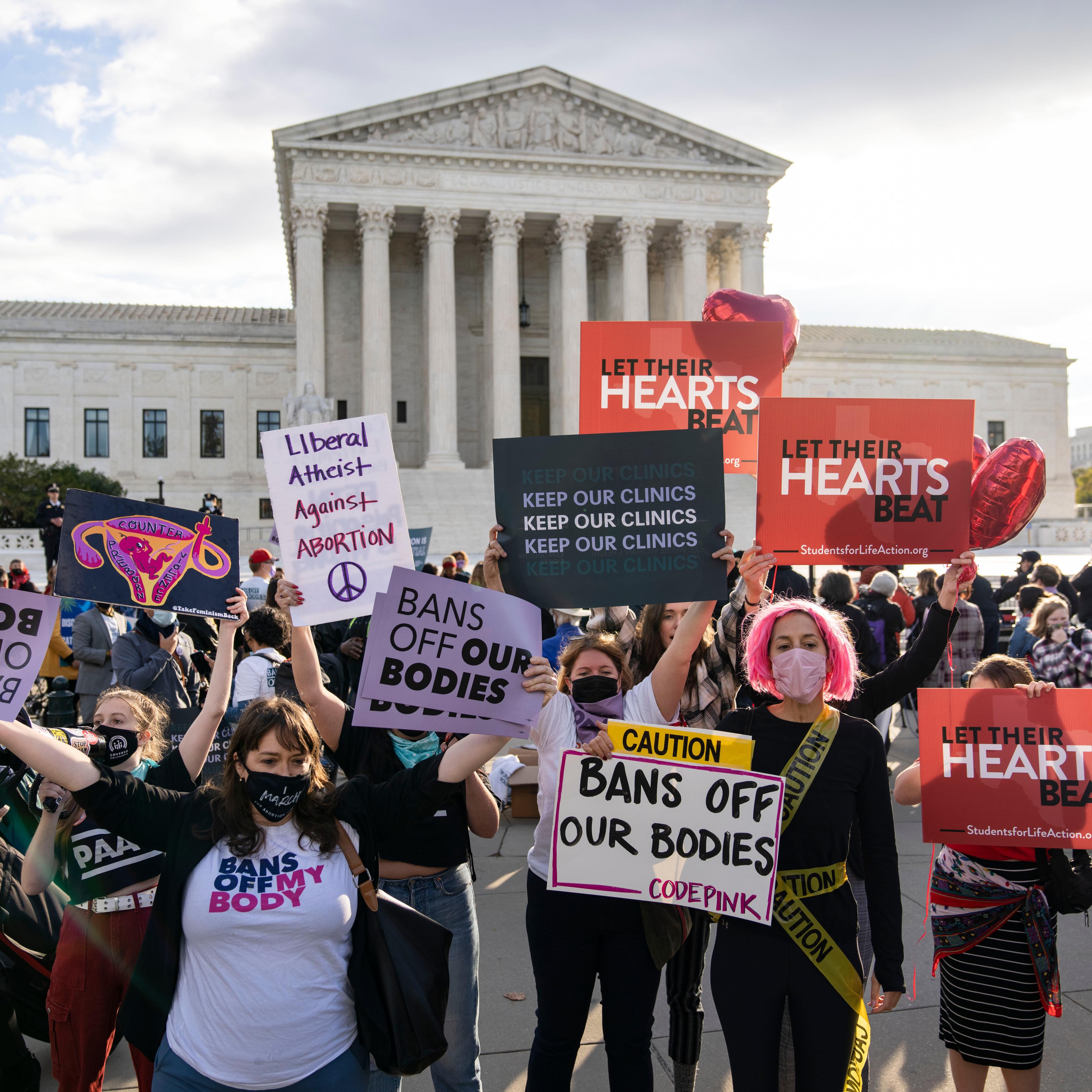 Abortion rights advocates and anti-abortion demonstrators rally outside the Supreme Court on Nov. 1, in Washington, D.C.