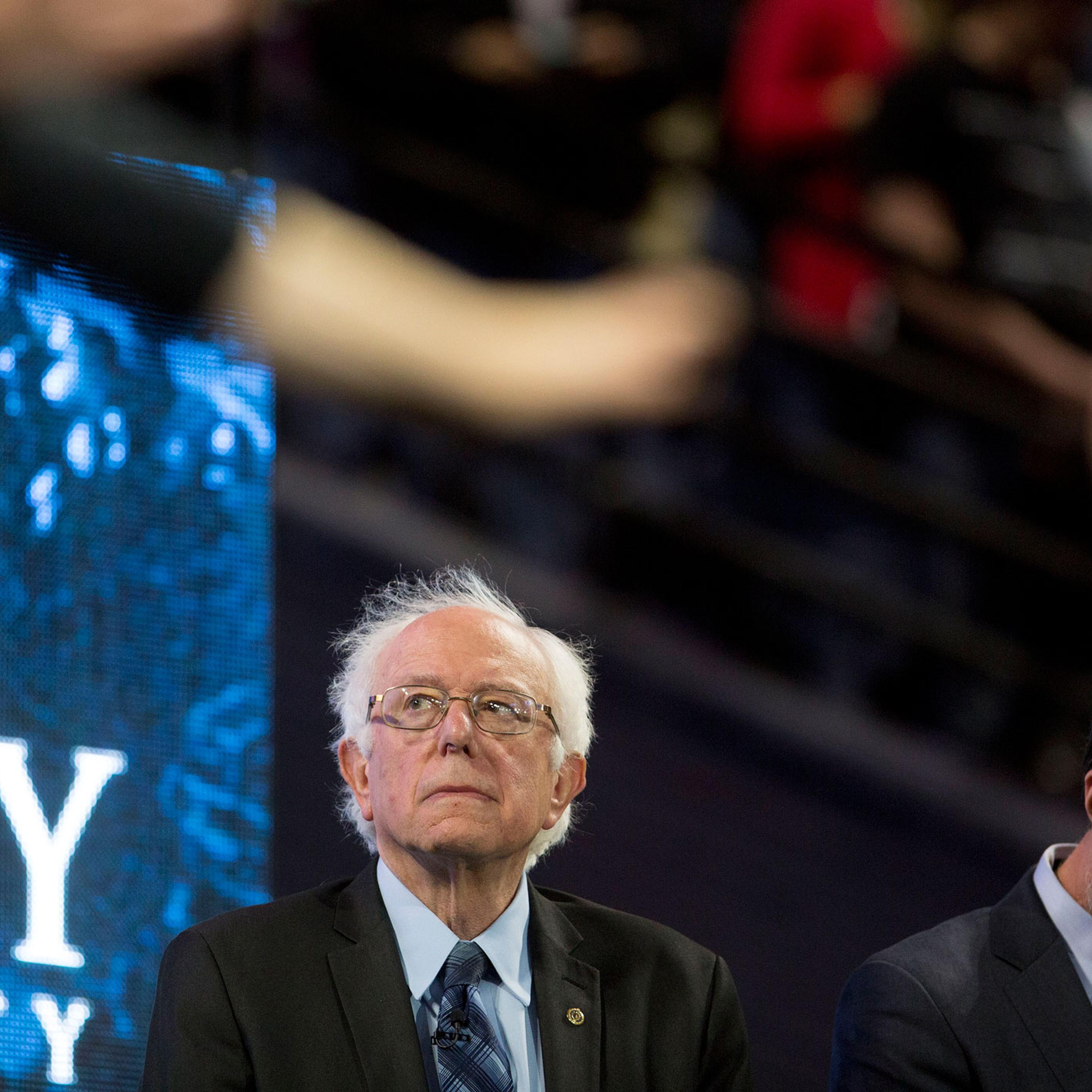 Senator Bernie Sanders, an independent from Vermont and 2016 Democratic presidential candidate, left, and Jerry Falwell Jr., president of Liberty University, listen to a prayer during a Liberty University Convocation in Lynchburg, Virginia, U.S., on Mond