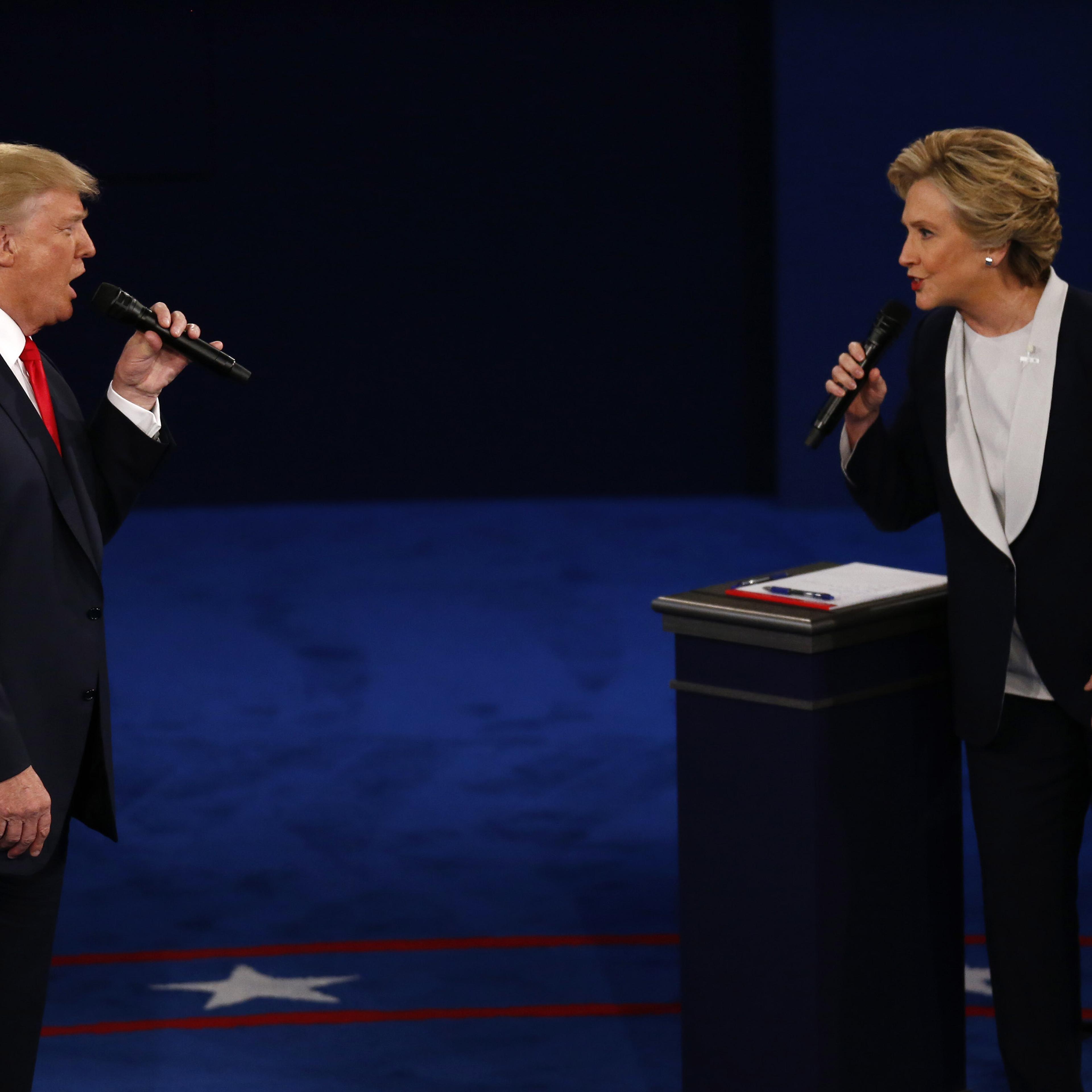 Donald Trump, 2016 Republican presidential nominee, and Hillary Clinton, 2016 Democratic presidential nominee, speak during the second U.S. presidential debate at Washington University in St. Louis, on Oct. 9, 2016.