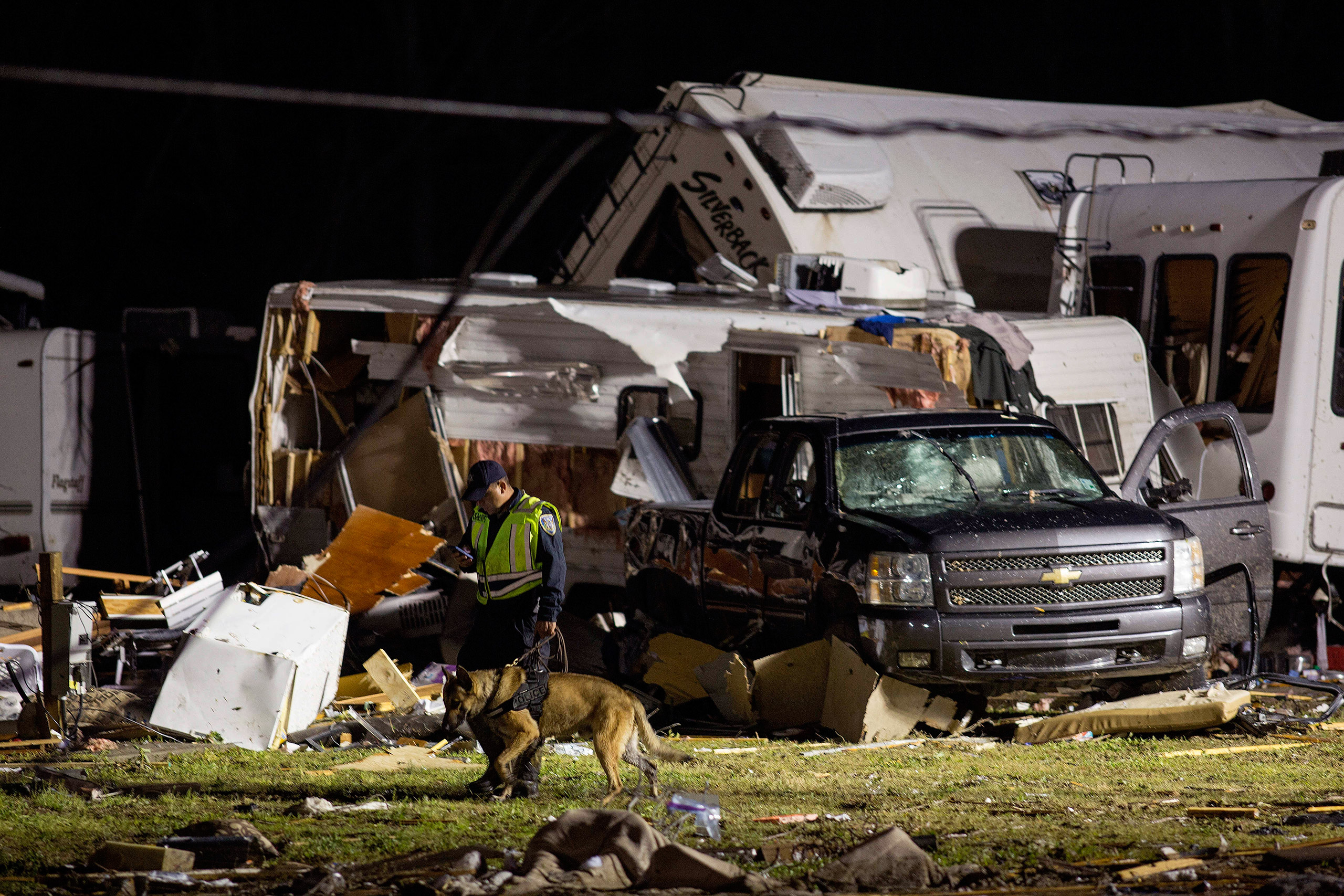 First responders search mangled trailers and vehicles after a suspected tornado hit the Sugar Hill RV Park in Convent, La., Feb. 23, 2016.