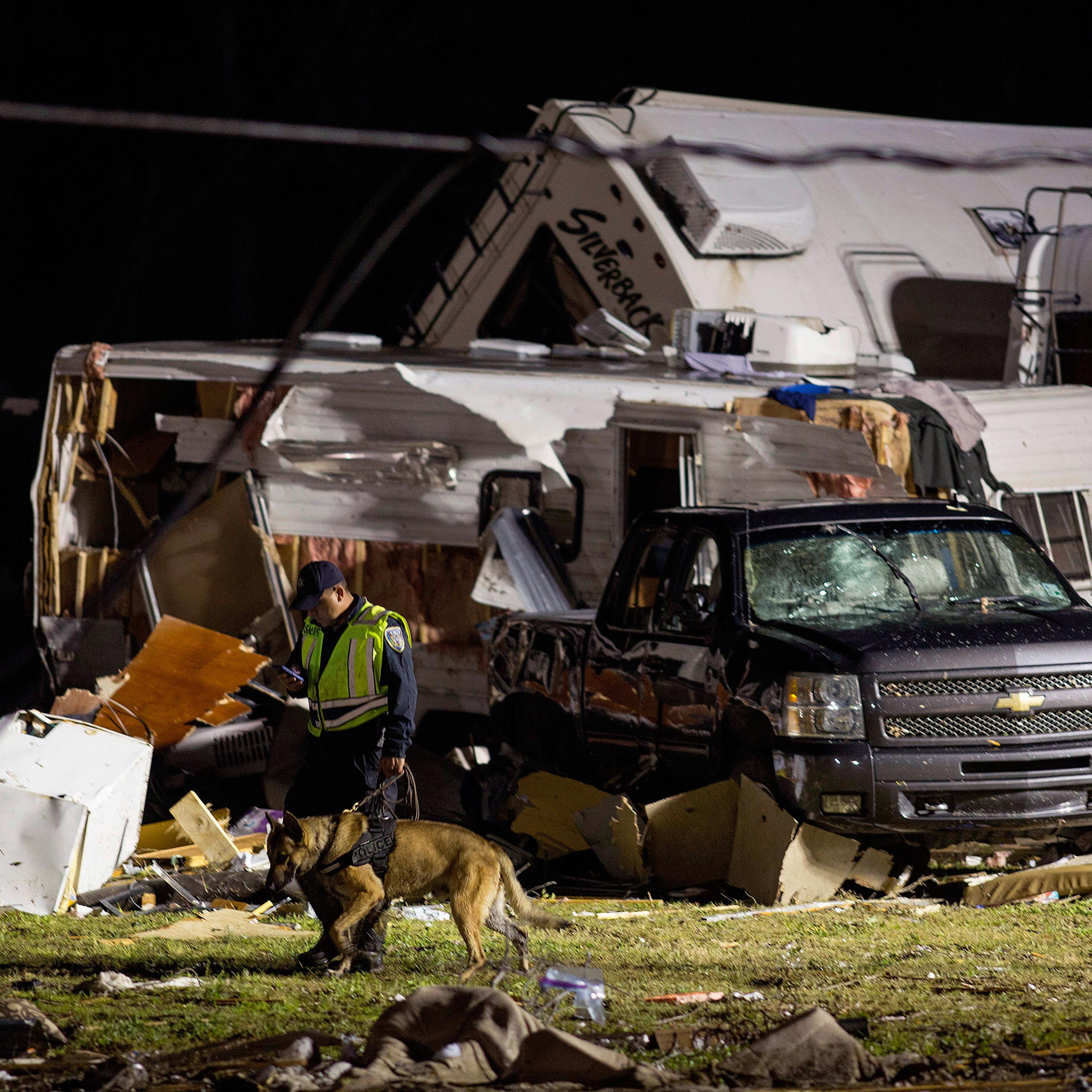 First responders search mangled trailers and vehicles after a suspected tornado hit the Sugar Hill RV Park in Convent, La., Feb. 23, 2016.