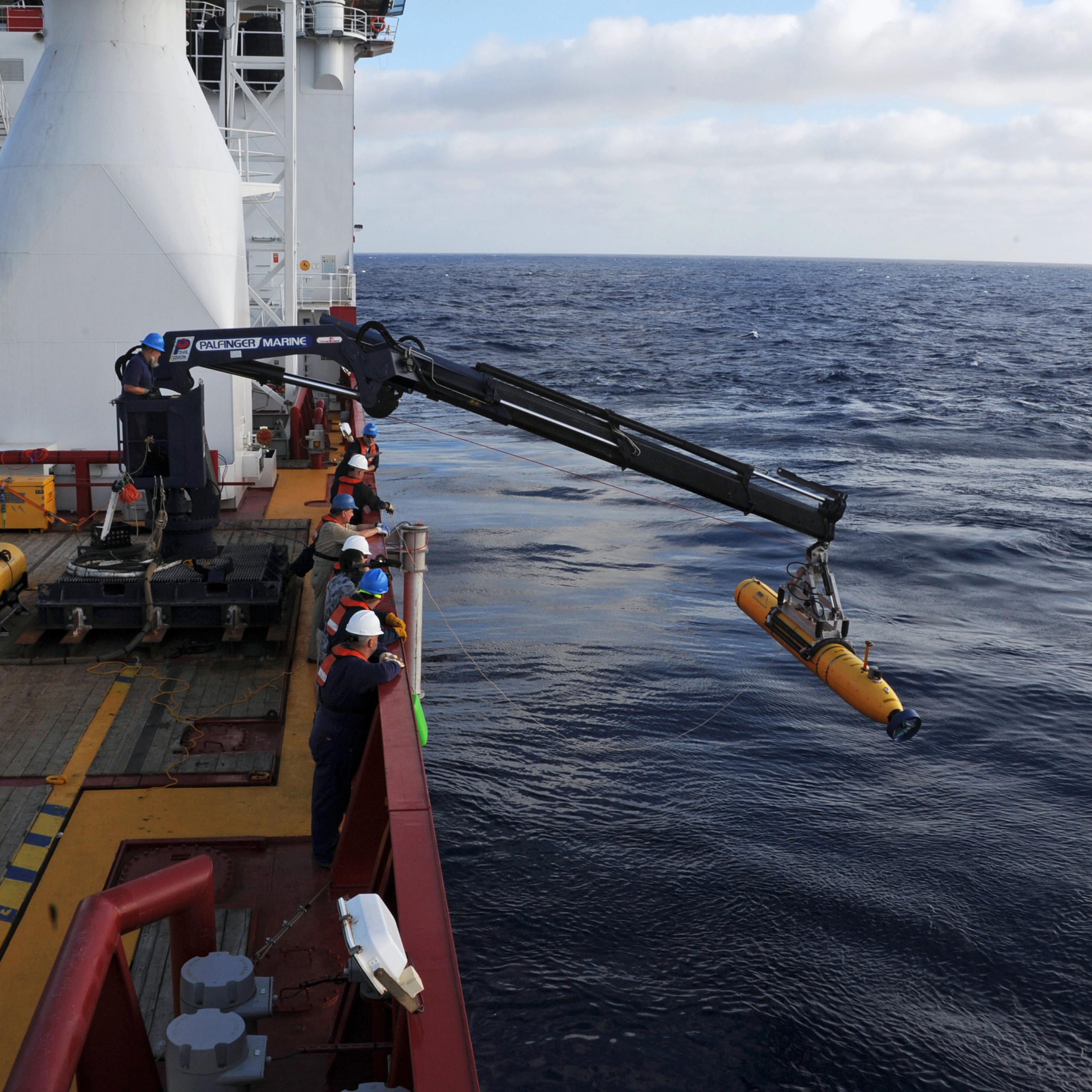 Handout of crew aboard the Australian Defence Vessel Ocean Shield moving the U.S. Navy's Bluefin-21 into position for deployment, in the southern Indian Ocean to look for the missing Malaysia Airlines flight MH370
