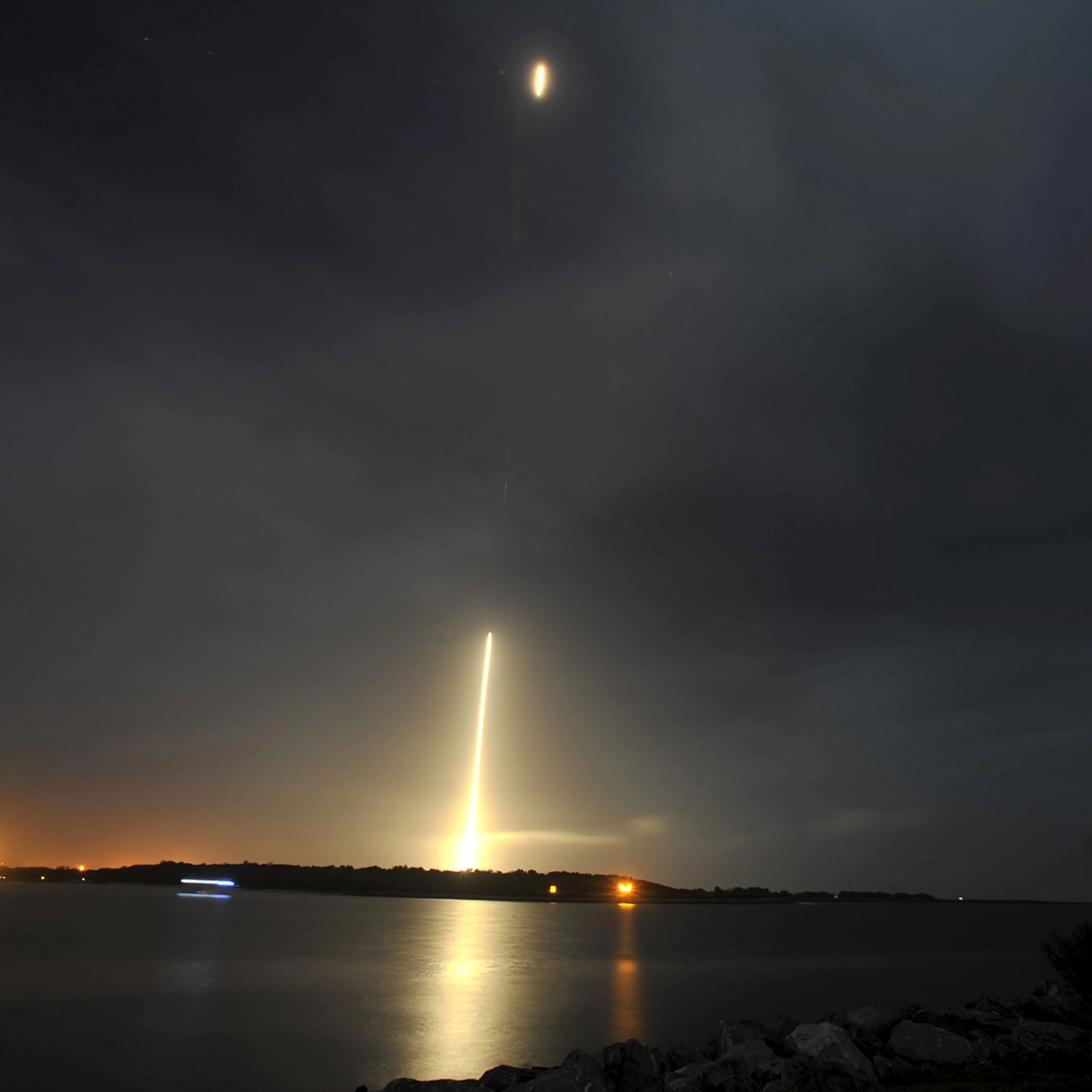 The SpaceX Falcon 9 rocket returns to a landing zone at the Cape Canaveral Air Force Station