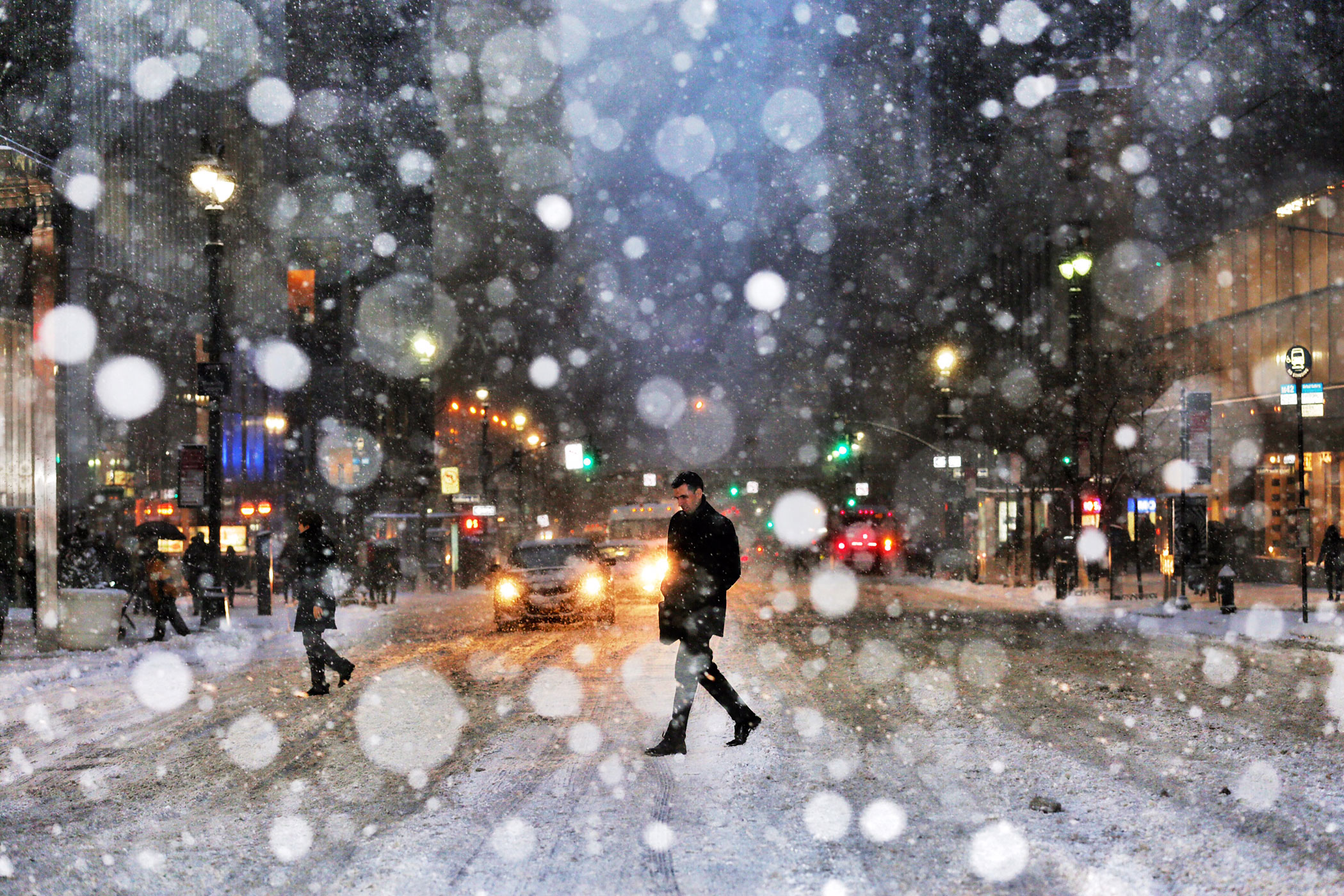 A man crosses the street in New York City during a snow storm in New York City on Jan. 26, 2015. 