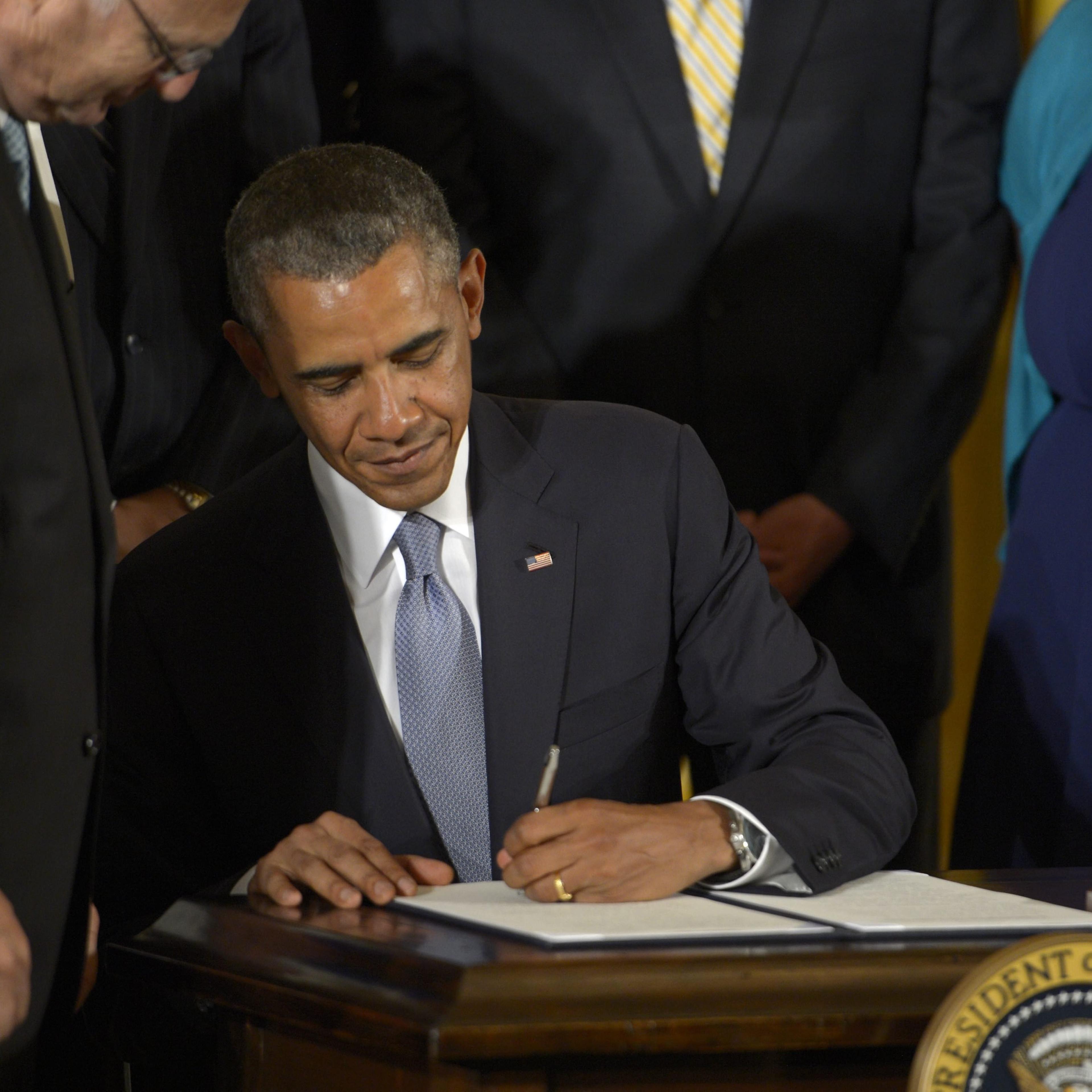 US President Barak Obama signs an Executive Order to protect LGBT employees from workplace discrimination during a ceremony in the the East Room of the White House in Washington on July 21, 2014.
