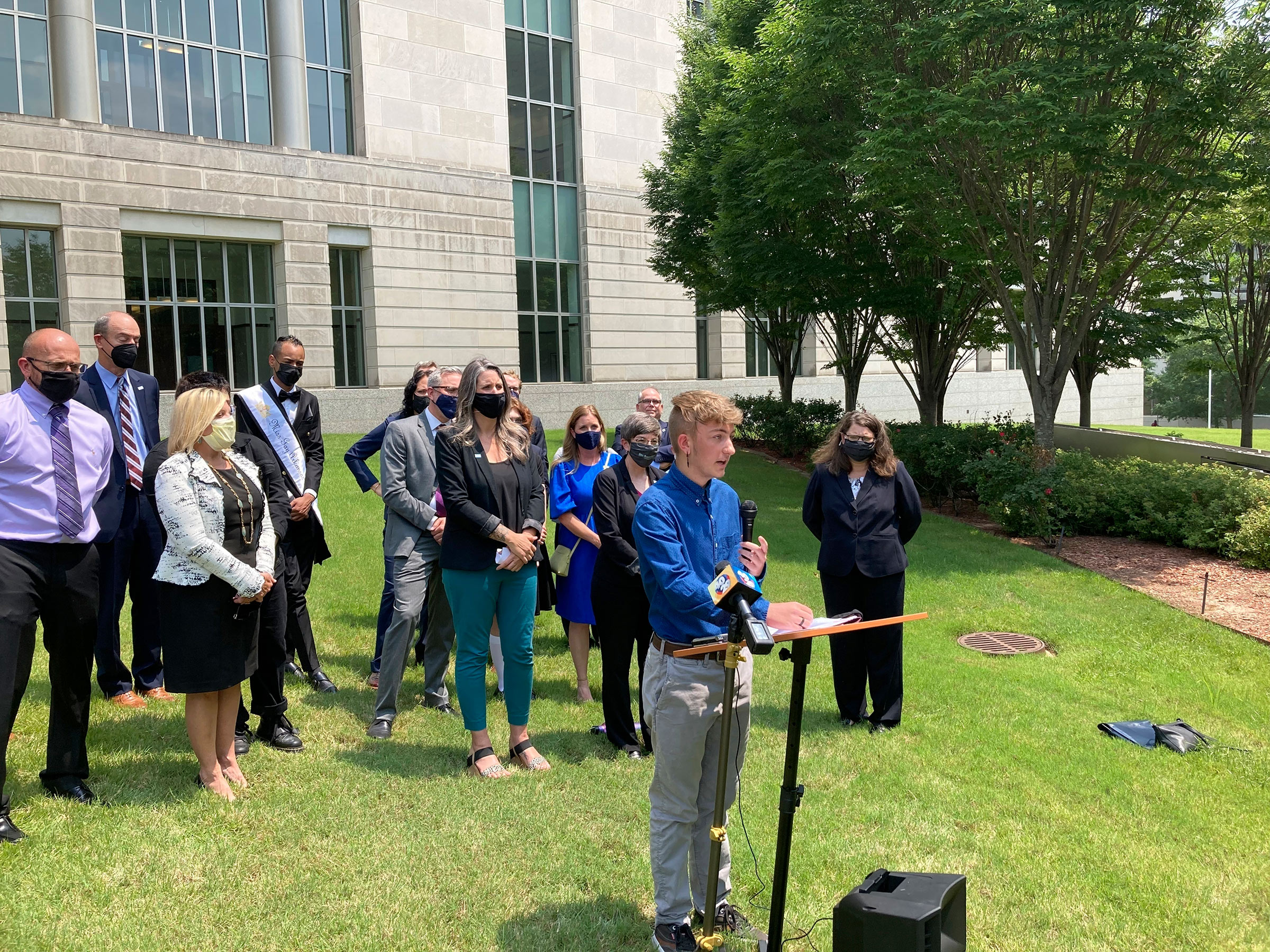 Dylan Brandt, a teenager, speaks at a news conference outside the federal courthouse in Little Rock, Arkansas.