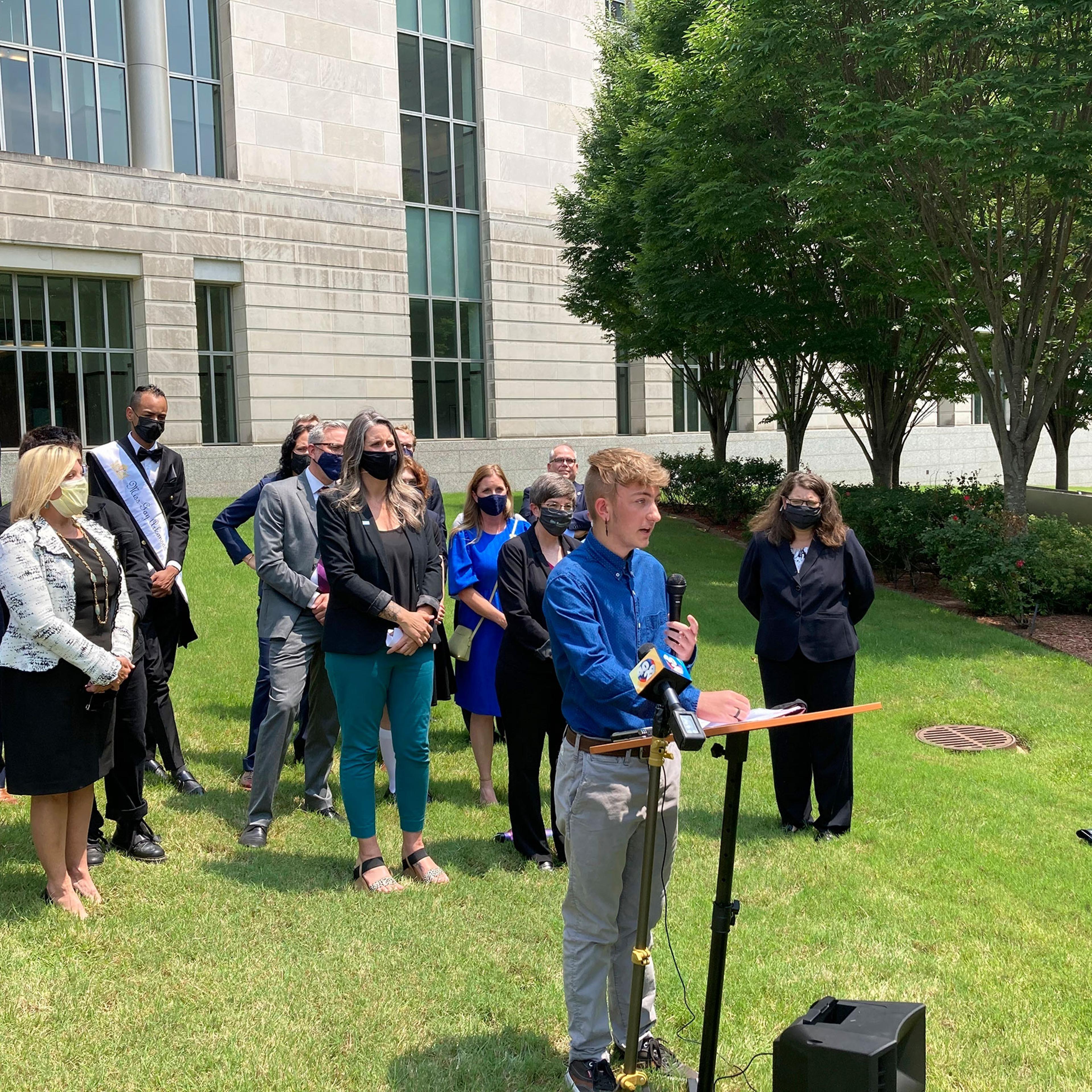 Dylan Brandt, a teenager, speaks at a news conference outside the federal courthouse in Little Rock, Arkansas.