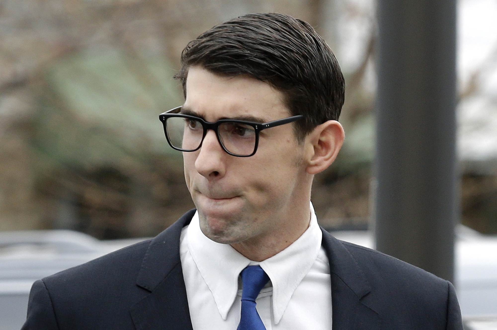 Olympic swimmer Michael Phelps walks into a courthouse in Baltimore, Md. for a trial on drunken driving and other charges on Dec. 19, 2014.