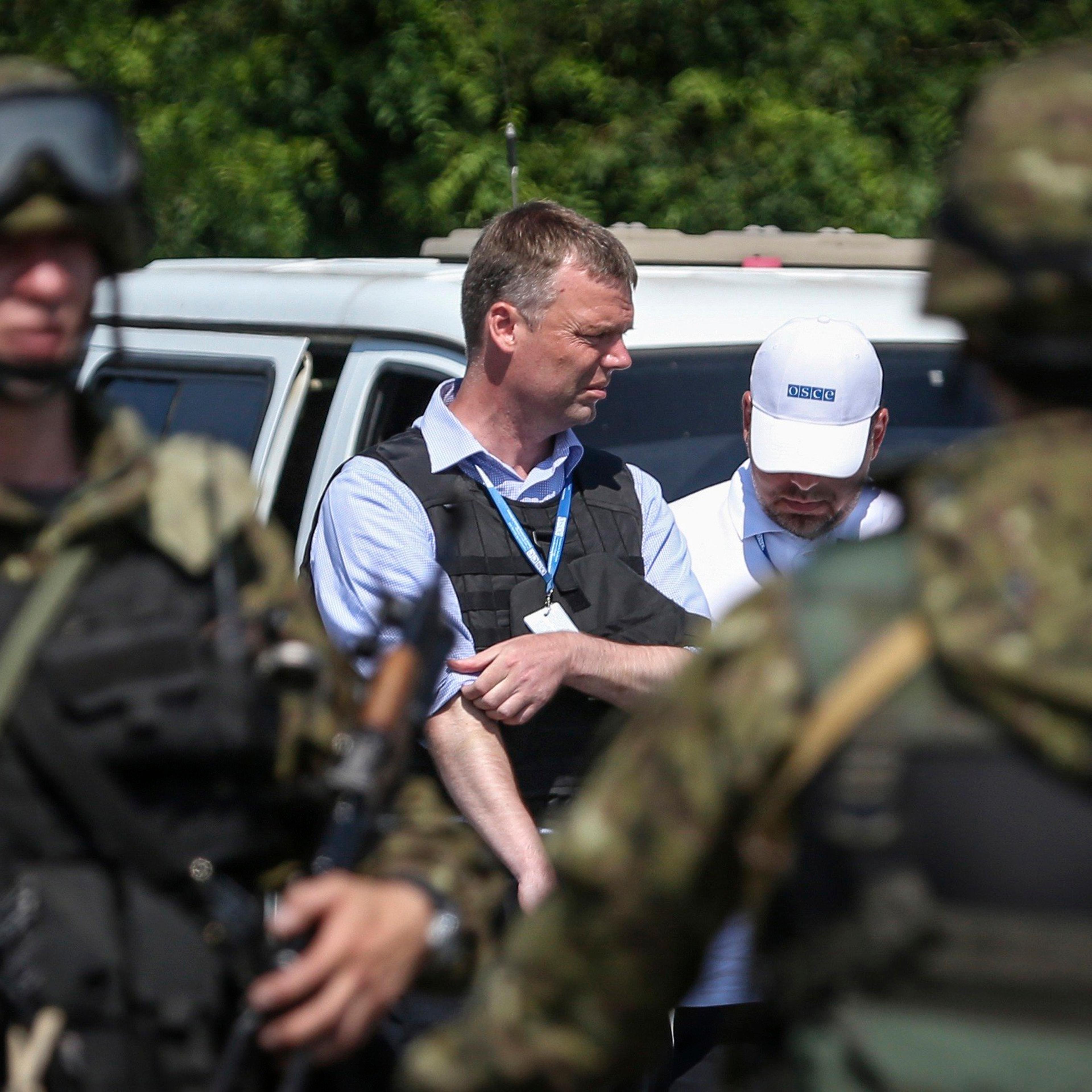 Alexander Hug deputy head for the Organisation for Security and Cooperation in Europe's (OSCE) monitoring mission in Ukraine, looks on next to armed pro-Russian separatists on the way to the Malaysia Airlines flight MH17 crash site, near Donetsk on July