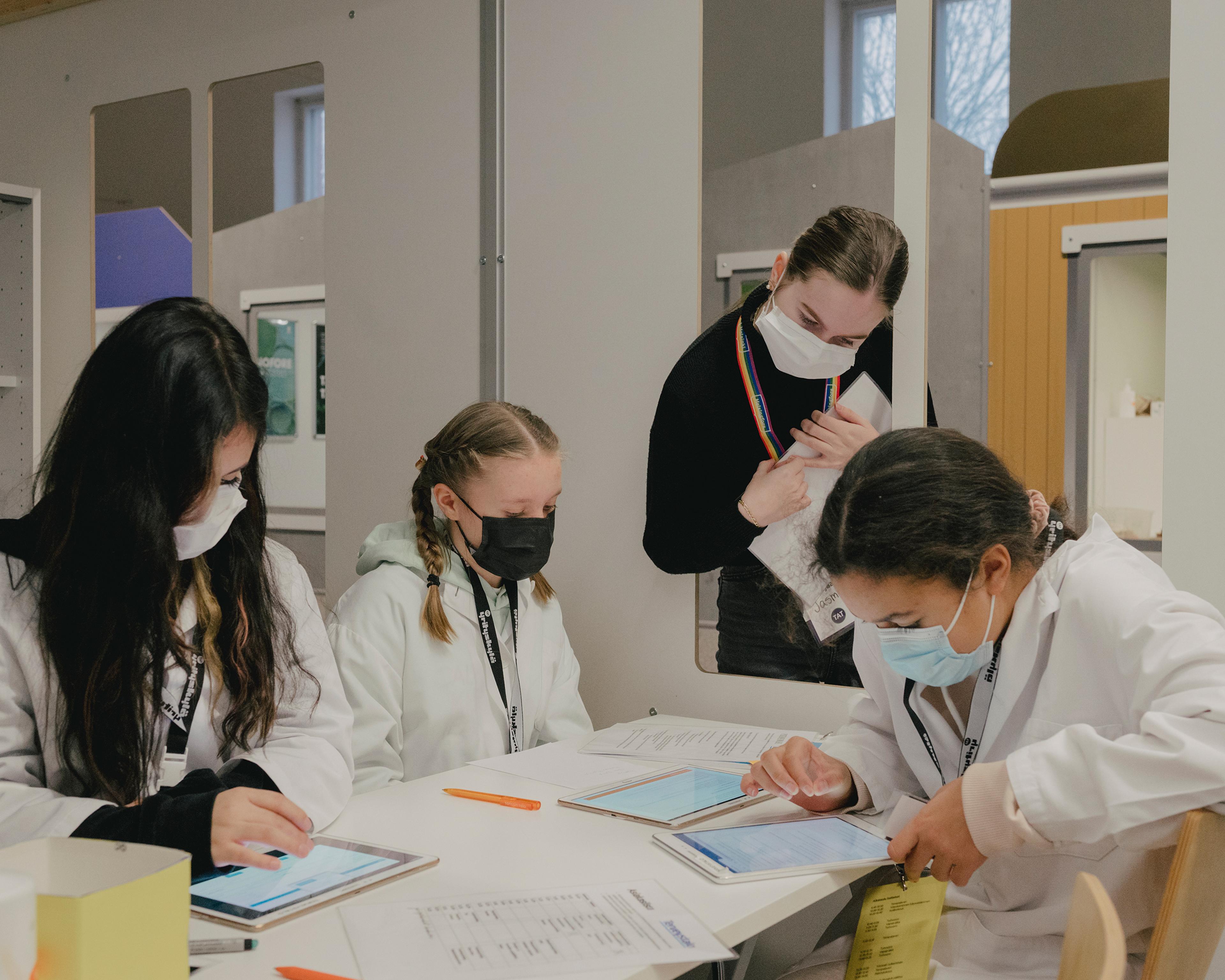 Students at Yrityskylä Learning Environment in Helsinki on Dec. 13. Through the tablets, students are able to access their schedules and job tasks