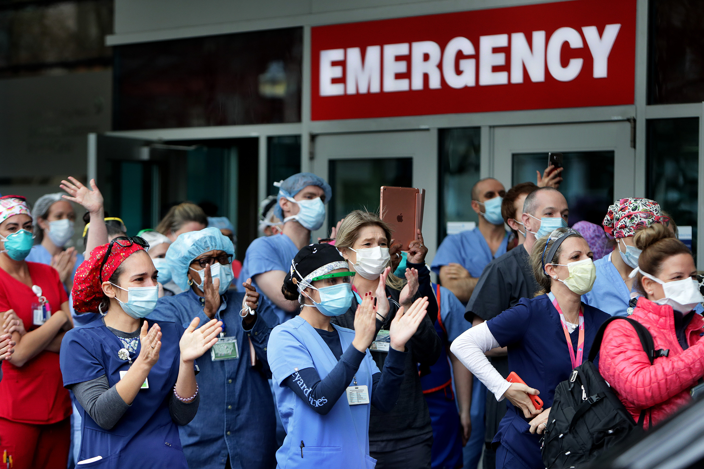 Staff cheer as a COVID-19 patient is released from Beth Israel Deaconess Medical Center in Boston on April 24, 2020.