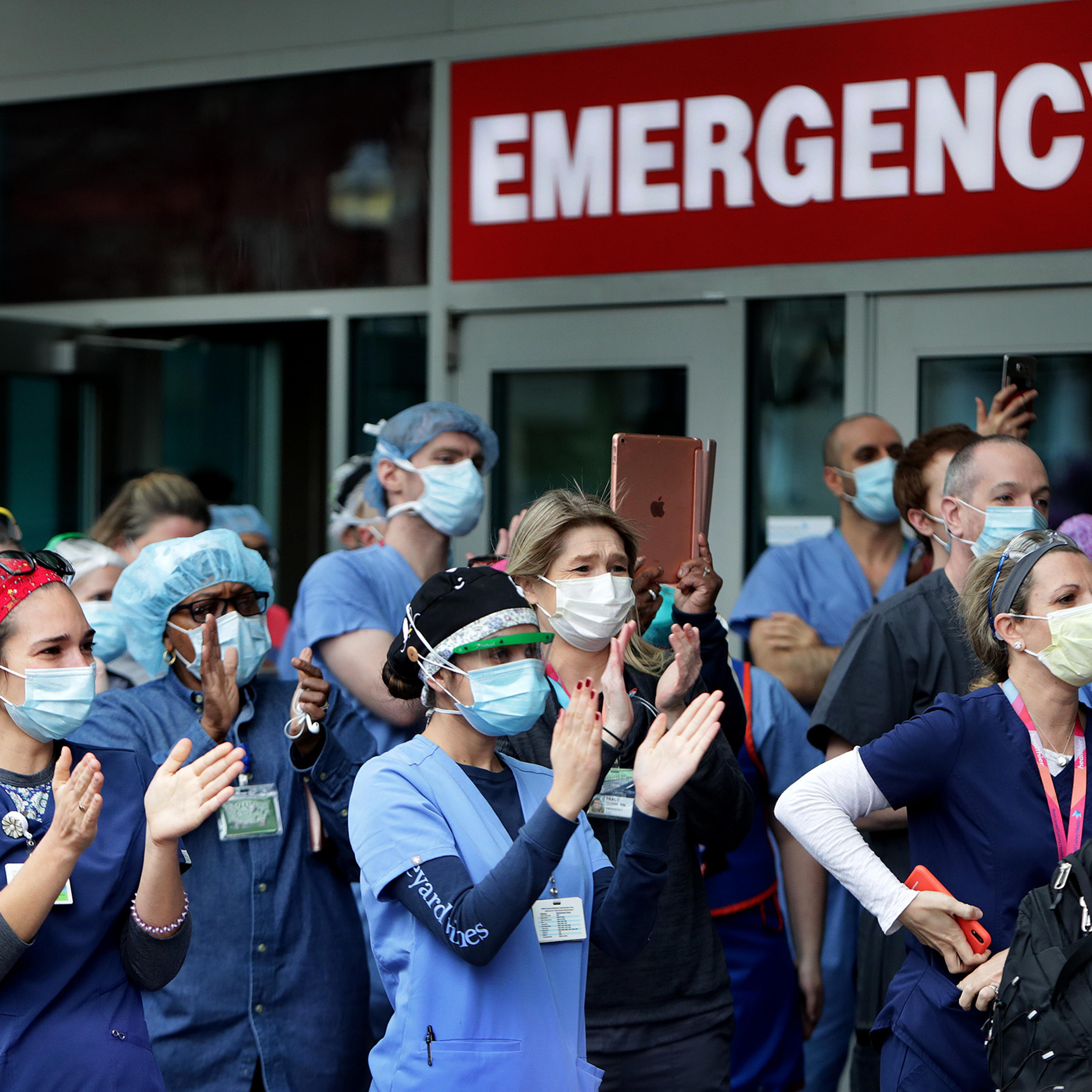 Staff cheer as a COVID-19 patient is released from Beth Israel Deaconess Medical Center in Boston on April 24, 2020.
