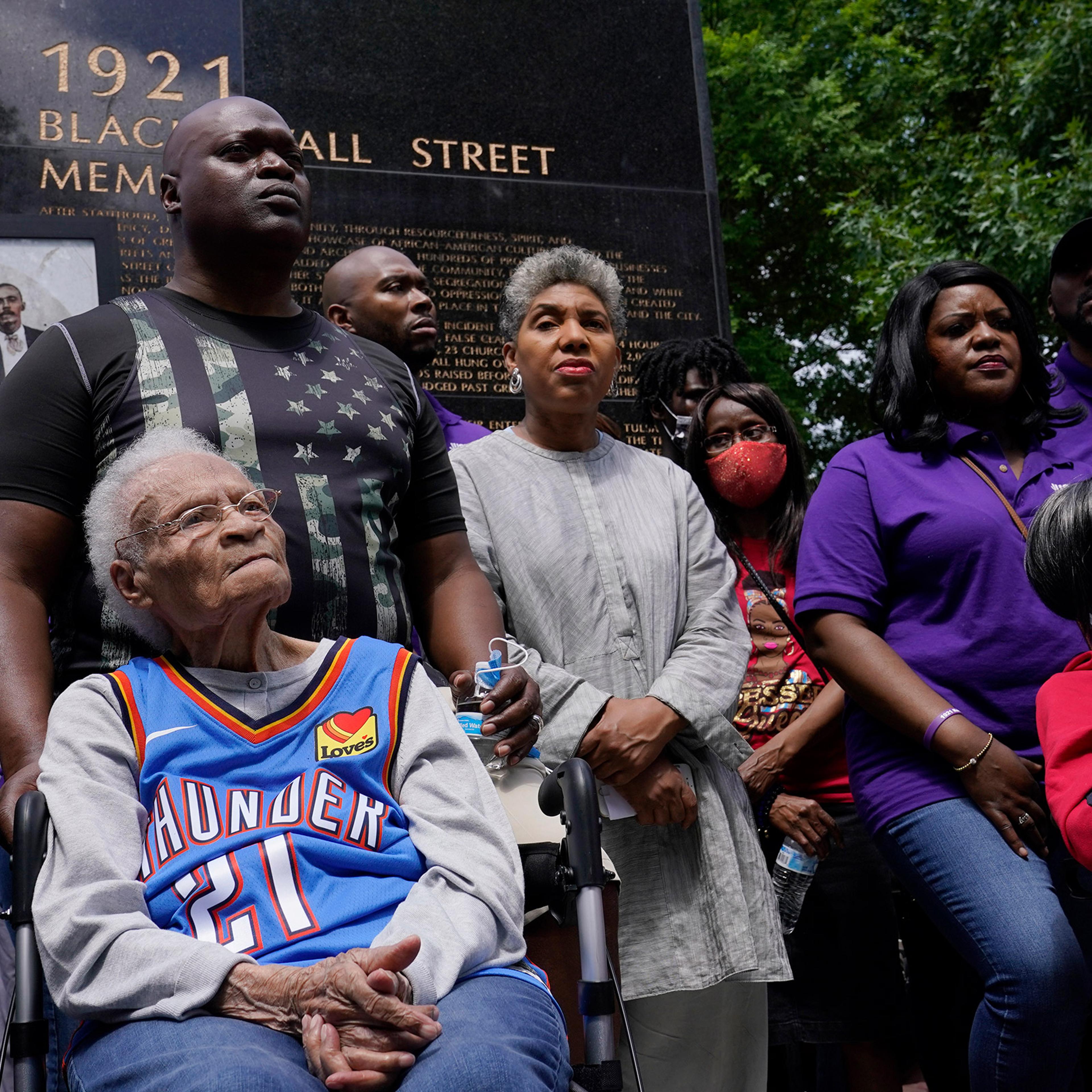 Tulsa race massacre survivors Viola Fletcher, left, and Lessie Benningfield Randle, right, listen during a rally marking centennial commemorations in Tulsa, Okla., May 28, 2021.