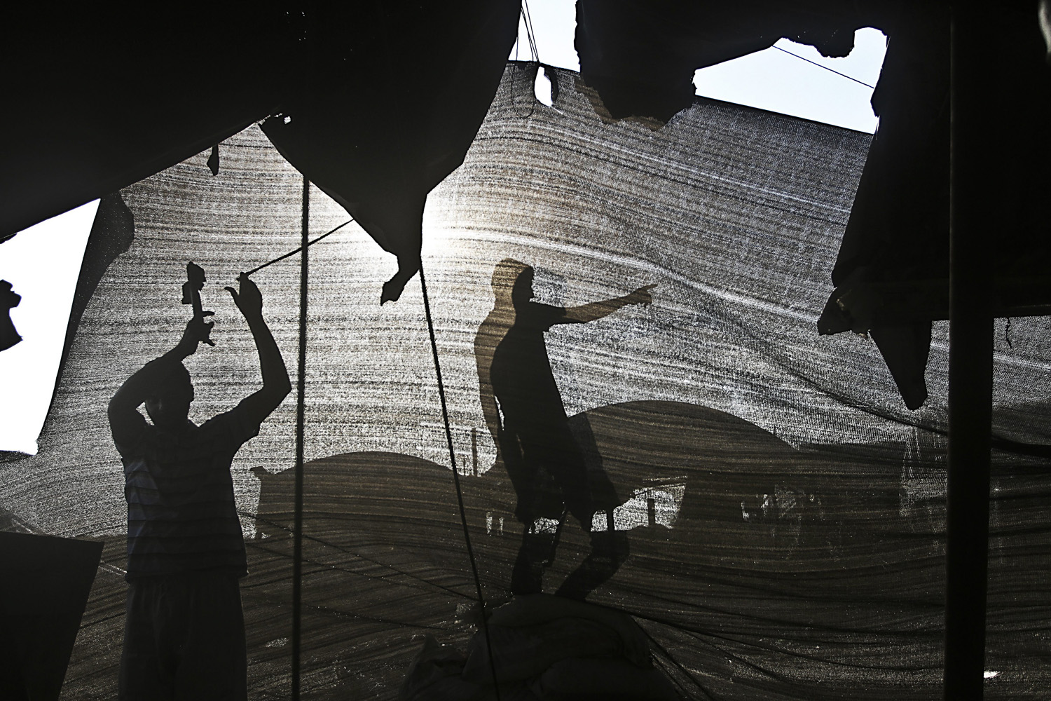 Dec. 2, 2012. Palestinian men repair a bombed smuggling tunnel connecting the Gaza Strip and Egypt, in Rafah, in the southern Gaza Strip.