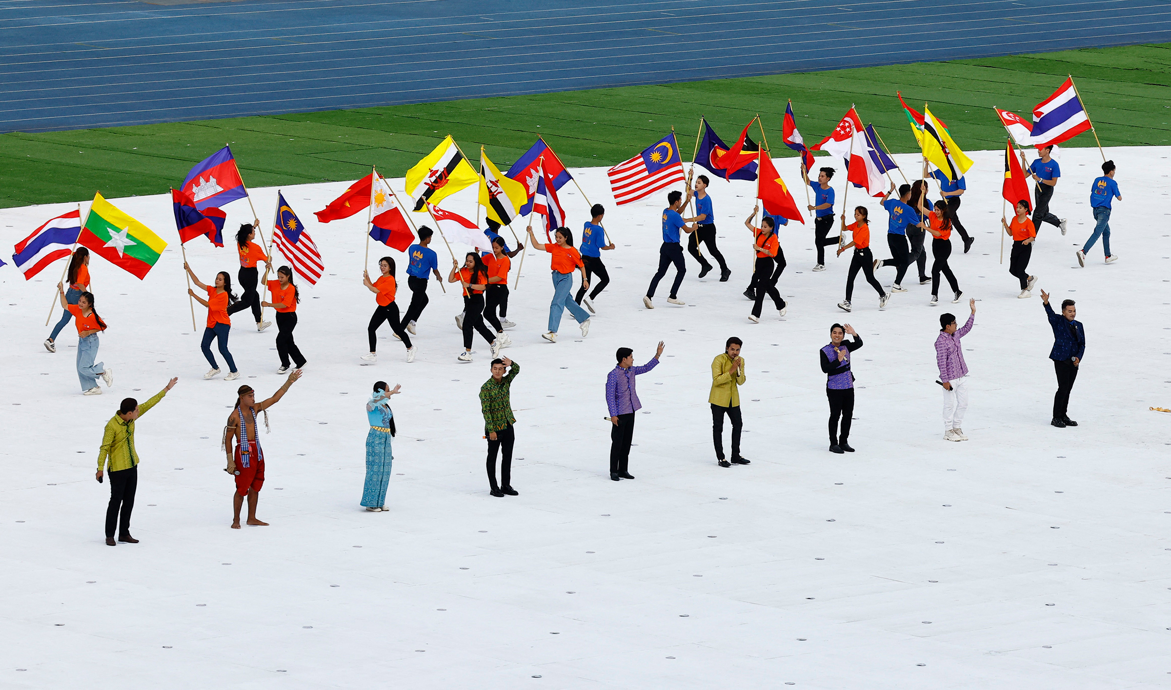 Performers carrying flags of participating nations during the opening ceremony of the 2023 Southeast Asia (SEA) Games at Morodok Techo National Stadium in Phnom Penh, Cambodia, May 5, 2023.
