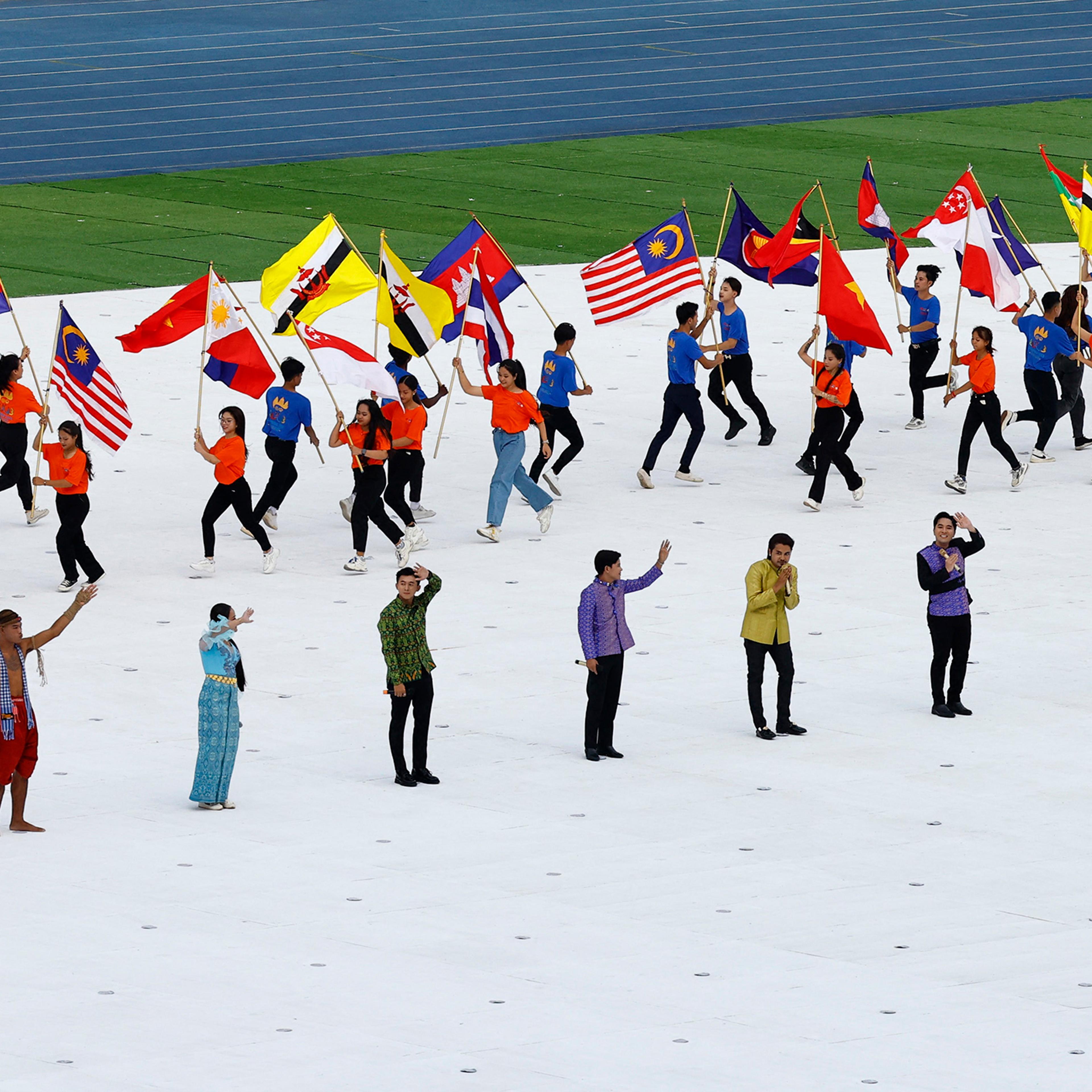 Performers carrying flags of participating nations during the opening ceremony of the 2023 Southeast Asia (SEA) Games at Morodok Techo National Stadium in Phnom Penh, Cambodia, May 5, 2023.