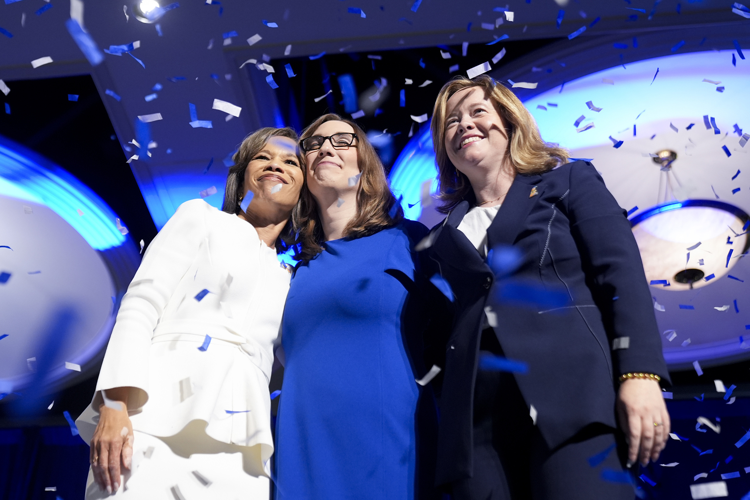 From left to right, Democratic Delaware Senate candidate state Rep. Lisa Blunt Rochester, Sarah McBride, Democratic candidate for Delaware's at-large congressional district, and Lt. Gov. Elect Kyle Gay embrace on stage during an election night watch part