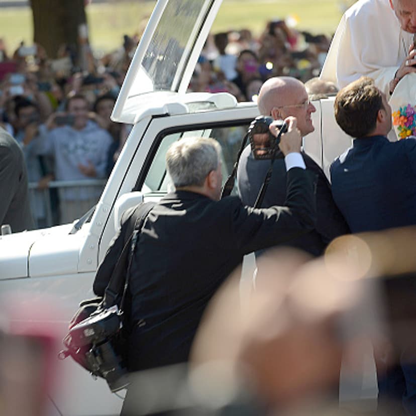 Pope Francis blesses a child handed to him during a parade on the streets around the Ellipse, south of the White House, September 23, 2015 in Washington, DC.