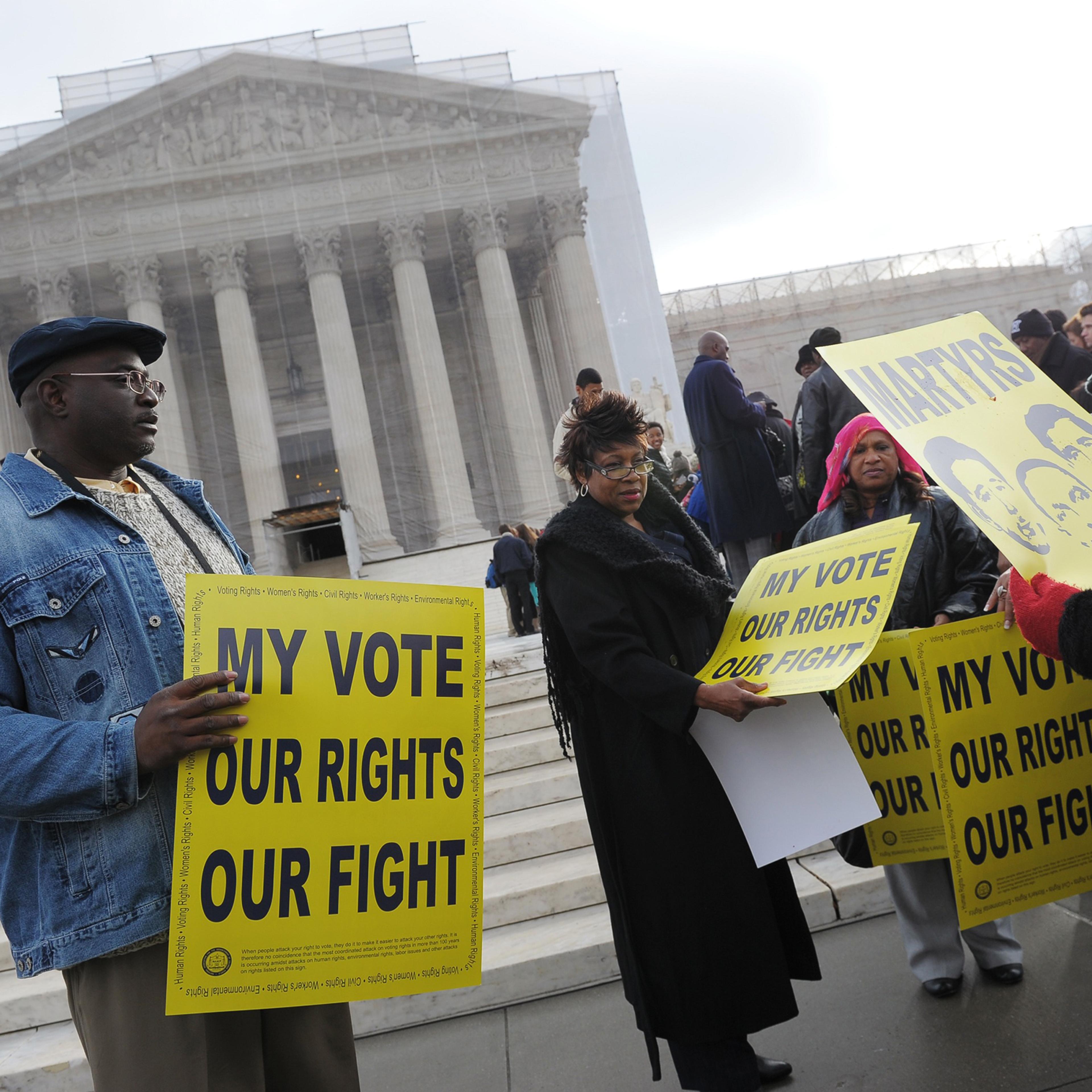 Activists distribute pro-voting rights placards outside the Supreme Court in Washington, D.C., on Feb. 27, 2013, as the Court prepares to hear Shelby County vs Holder.