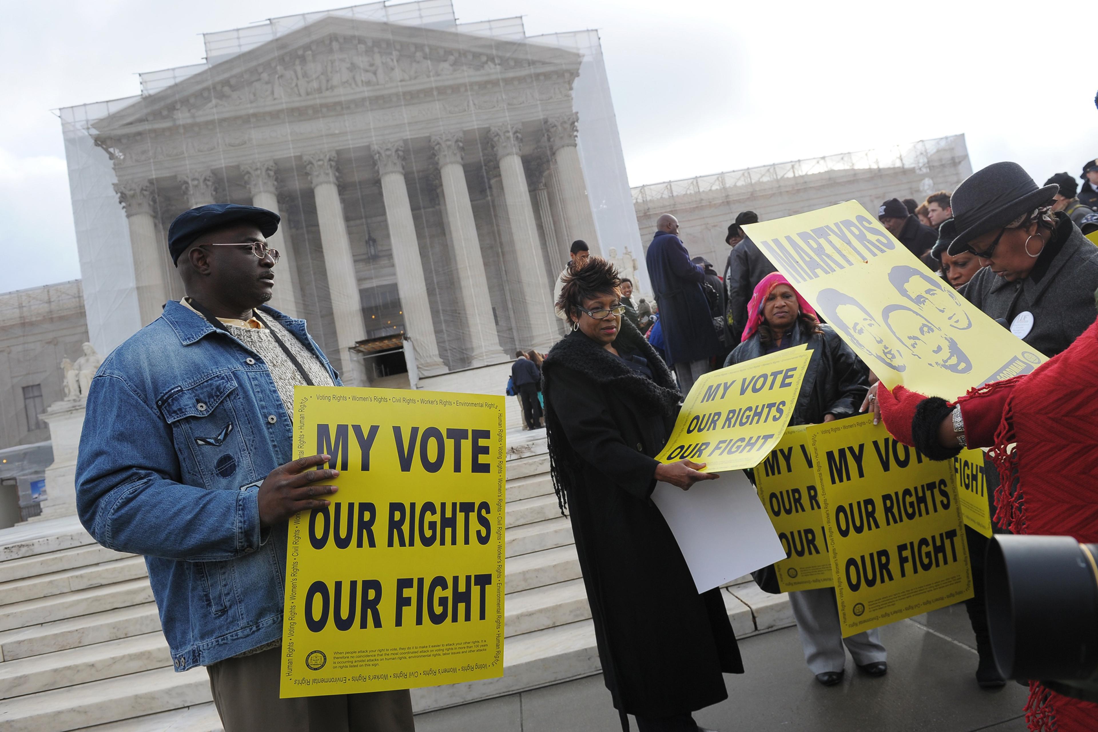 Activists distribute pro-voting rights placards outside the Supreme Court in Washington, D.C., on Feb. 27, 2013, as the Court prepares to hear Shelby County vs Holder.