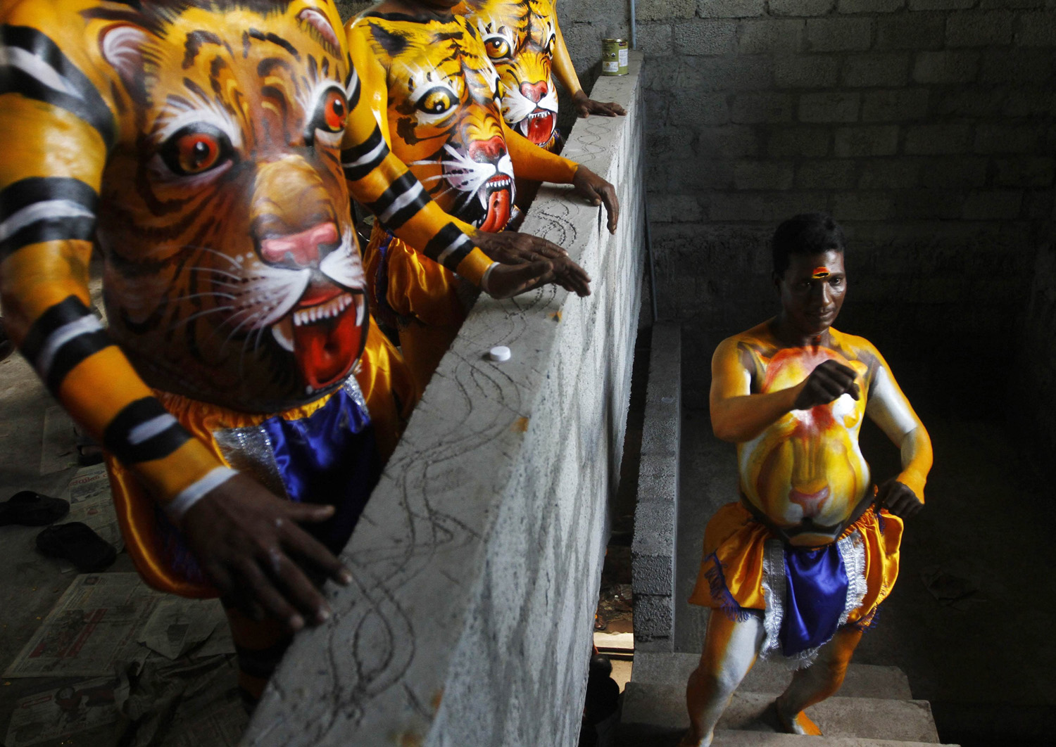A performer practices a dance move before taking part in at the festivities marking the end of the annual harvest festival of Onam in Trichur, in the southern Indian state of Kerala on Sept. 10, 2014.