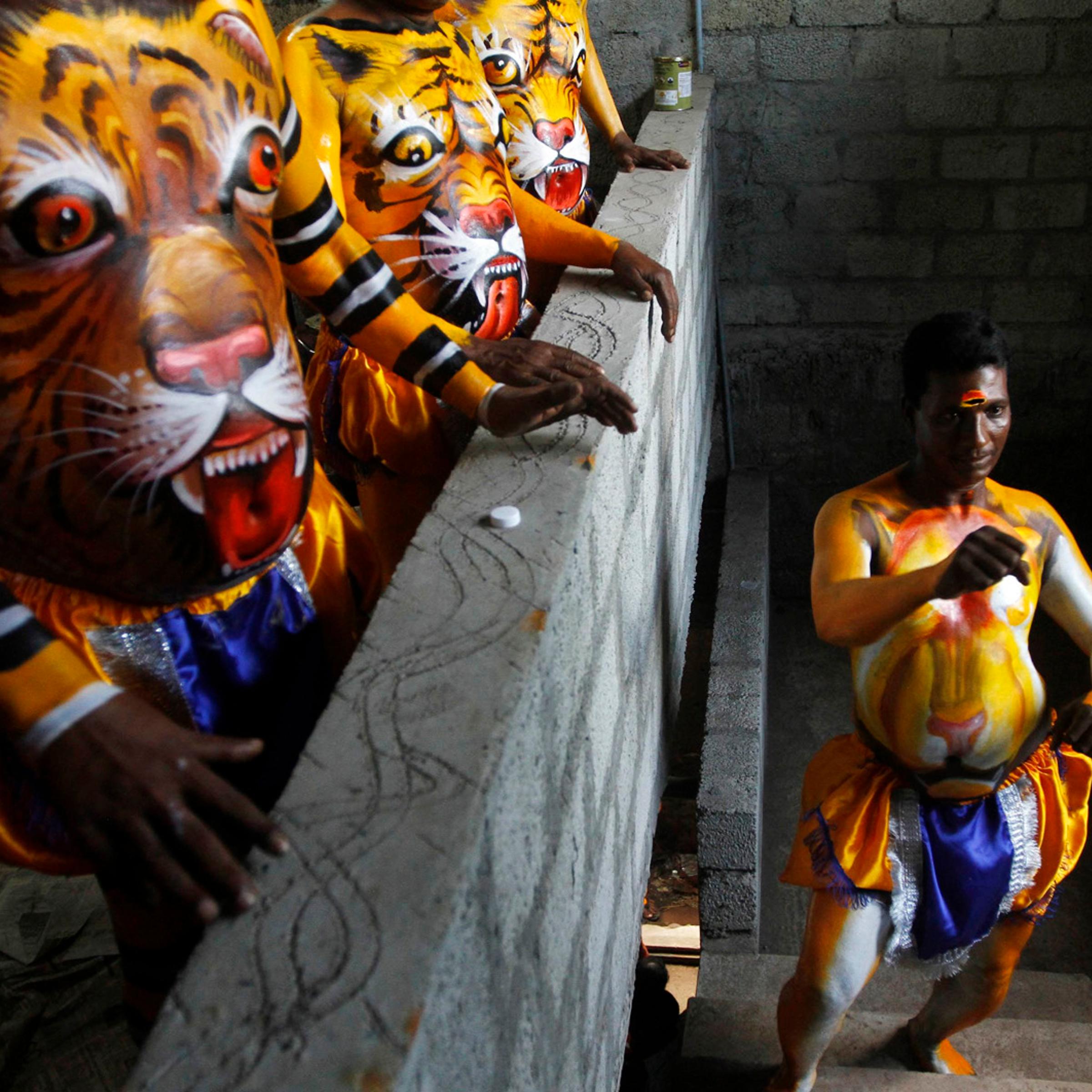 A performer practices a dance move before taking part in at the festivities marking the end of the annual harvest festival of Onam in Trichur, in the southern Indian state of Kerala on Sept. 10, 2014.