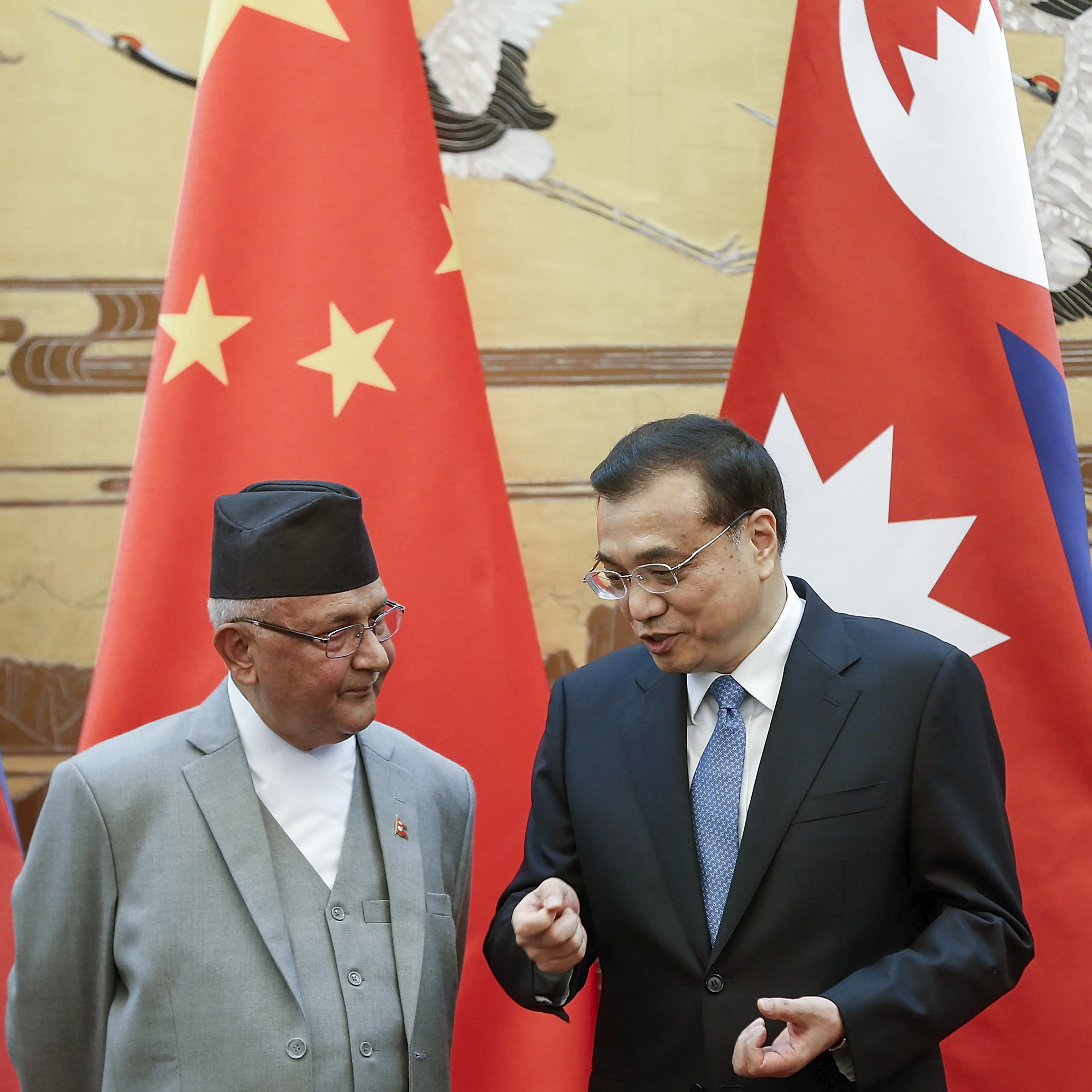 Chinese Premier Li Keqiang talks to Nepal Prime Minister Khadga Prasad Sharma Oli during a signing ceremony at the Great Hall of the People in Beijing