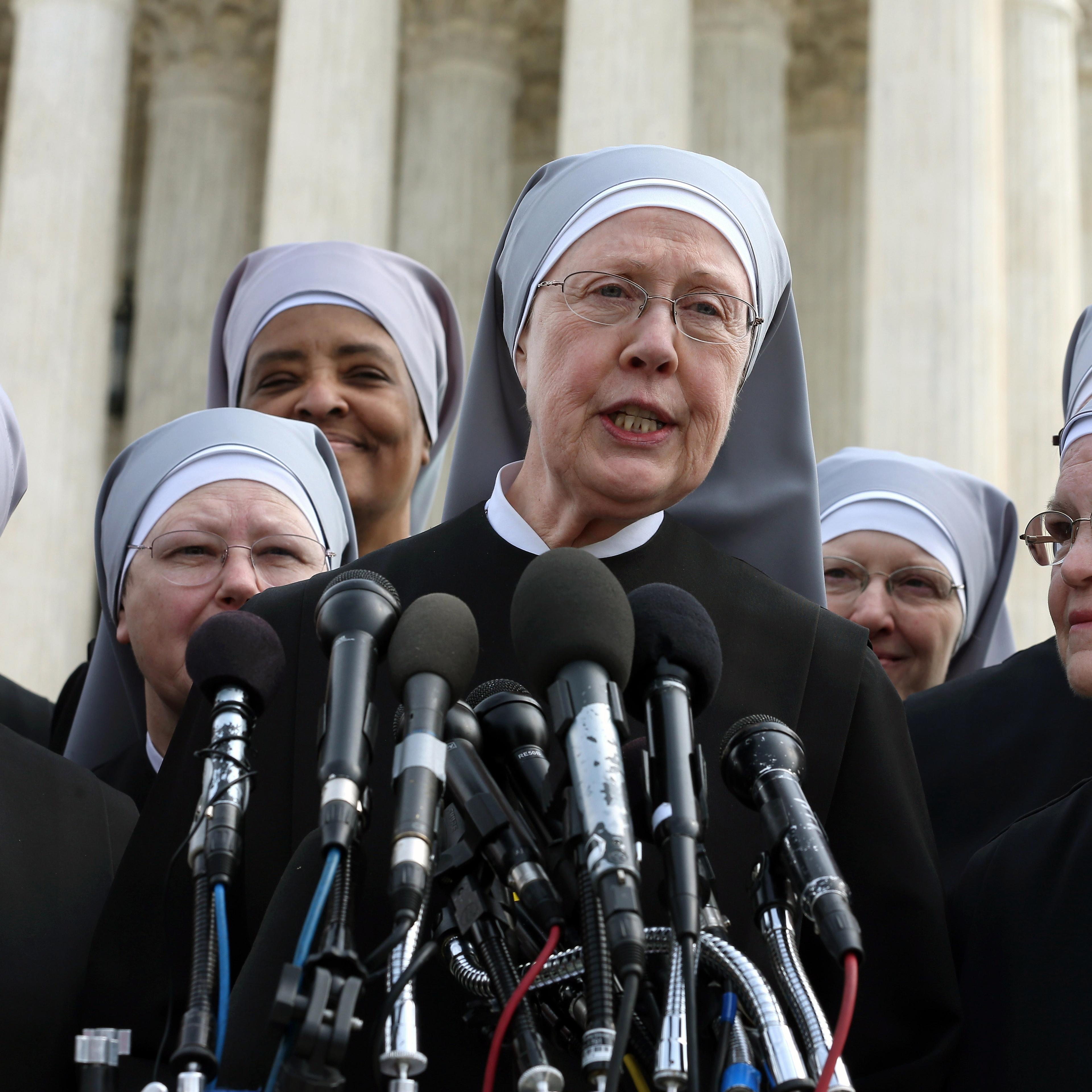 Mother Loraine Marie Maguire, (L), of the Little Sisters of the Poor, speaks to the media after arguments at the U.S. Supreme Court, in Washington, D.C., on March 23, 2016.