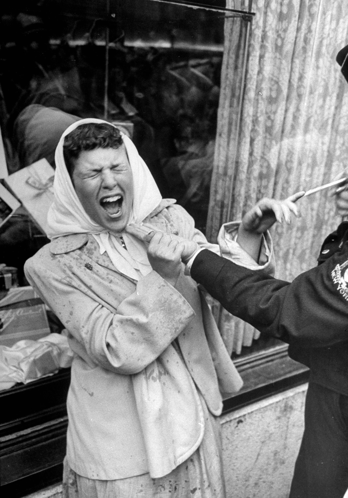 A woman getting sprayed by a man as a jo