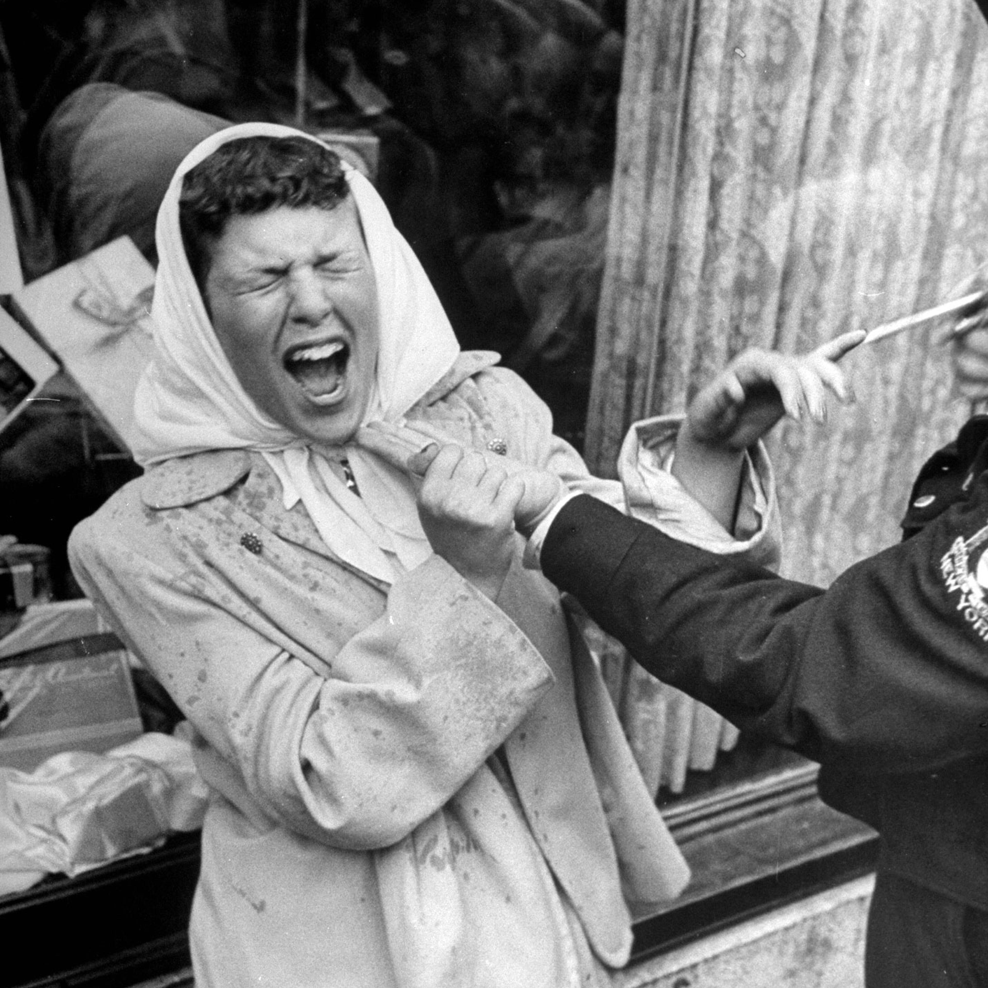 A woman getting sprayed by a man as a jo