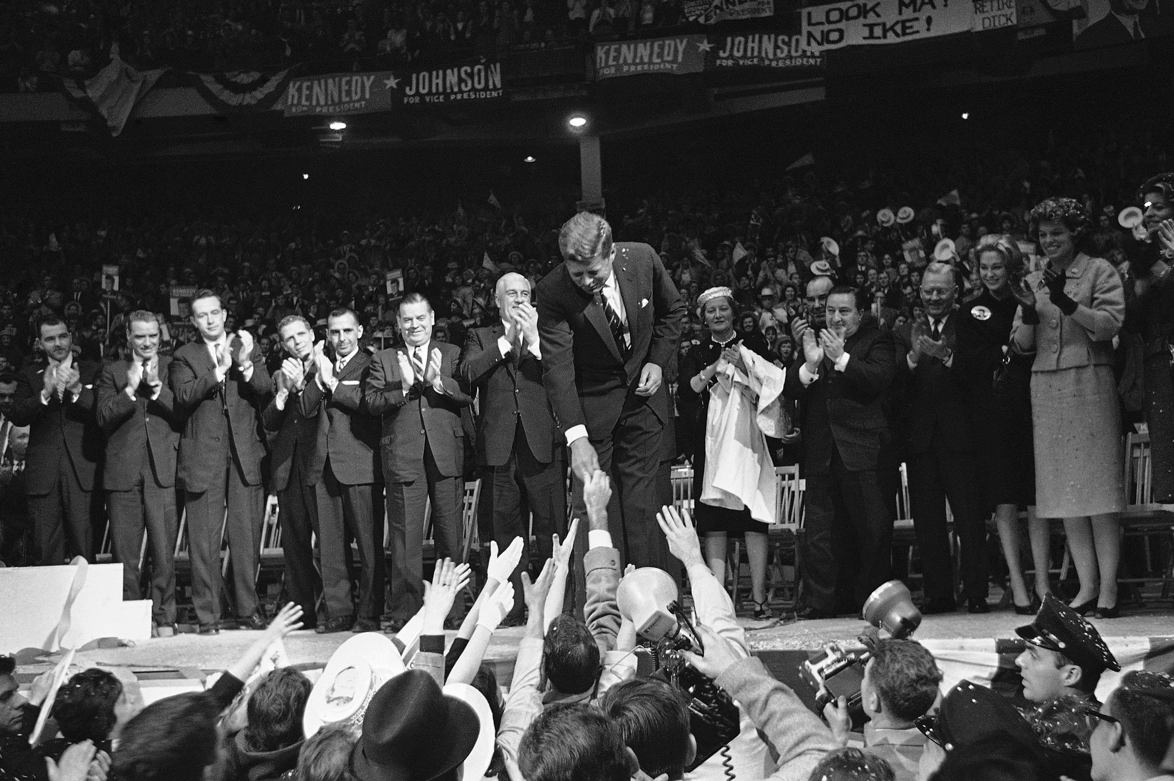 John F. Kennedy shaking hands in front of a crowd