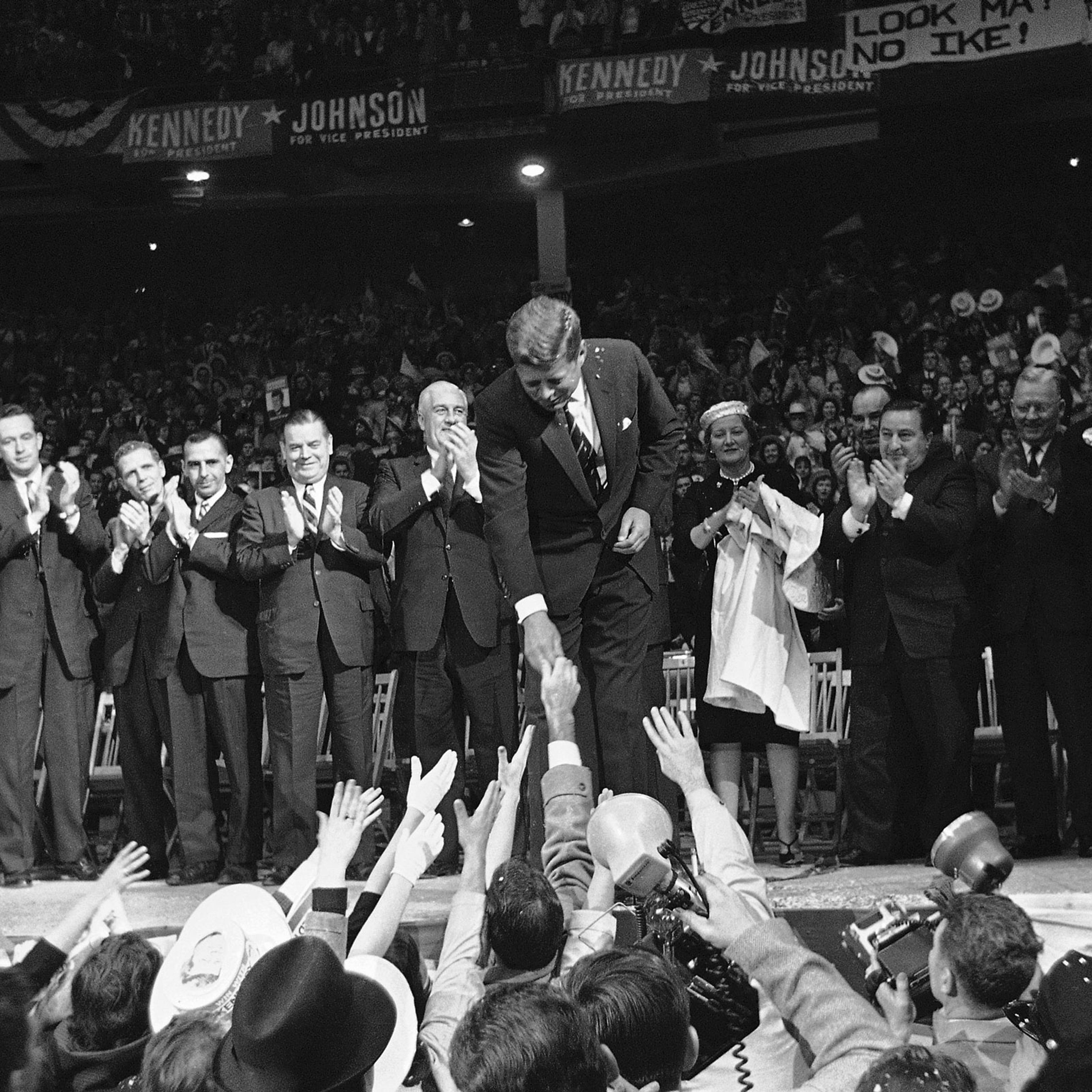 John F. Kennedy shaking hands in front of a crowd